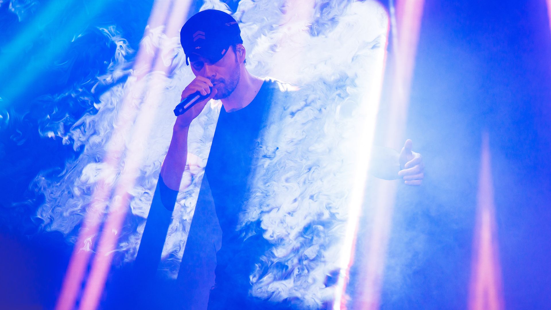 Enrique Iglesias emerges from a cloud of smoke onstage in Toronto as part of the trilogy tour with Pitbull and Ricky Martin.