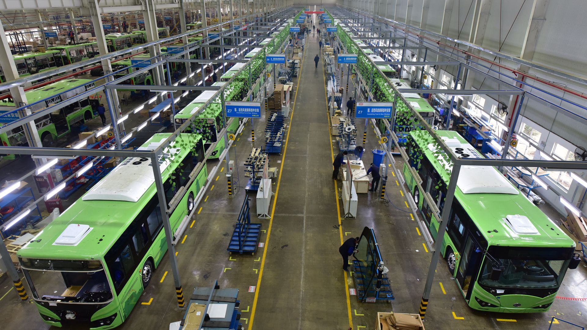 Employees work on the assembly line of the electric bus at a BYD's production base on January 23, 2018 in Xi an, Shaanxi Province of China