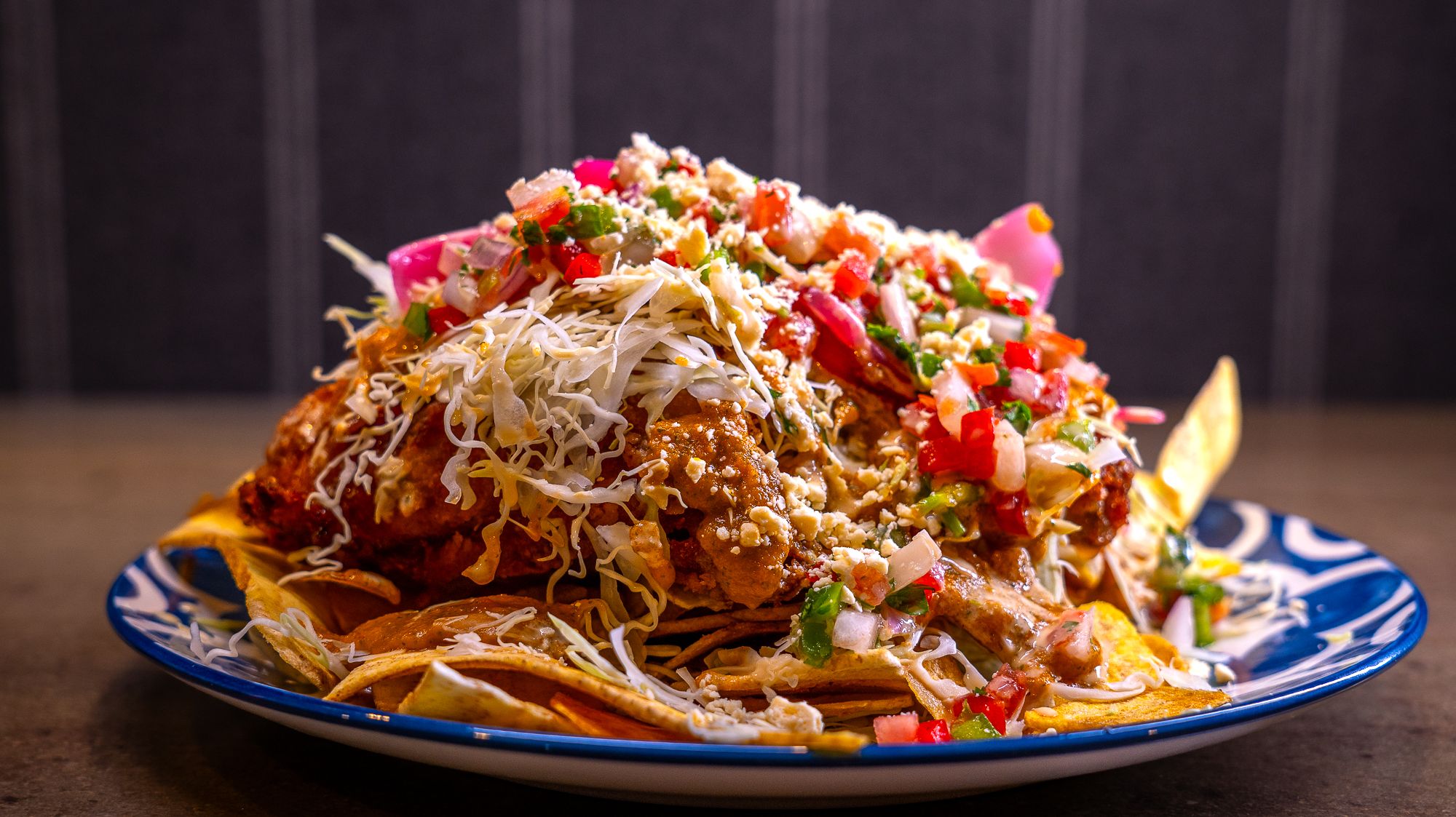 A plate of nachos on a blue plate