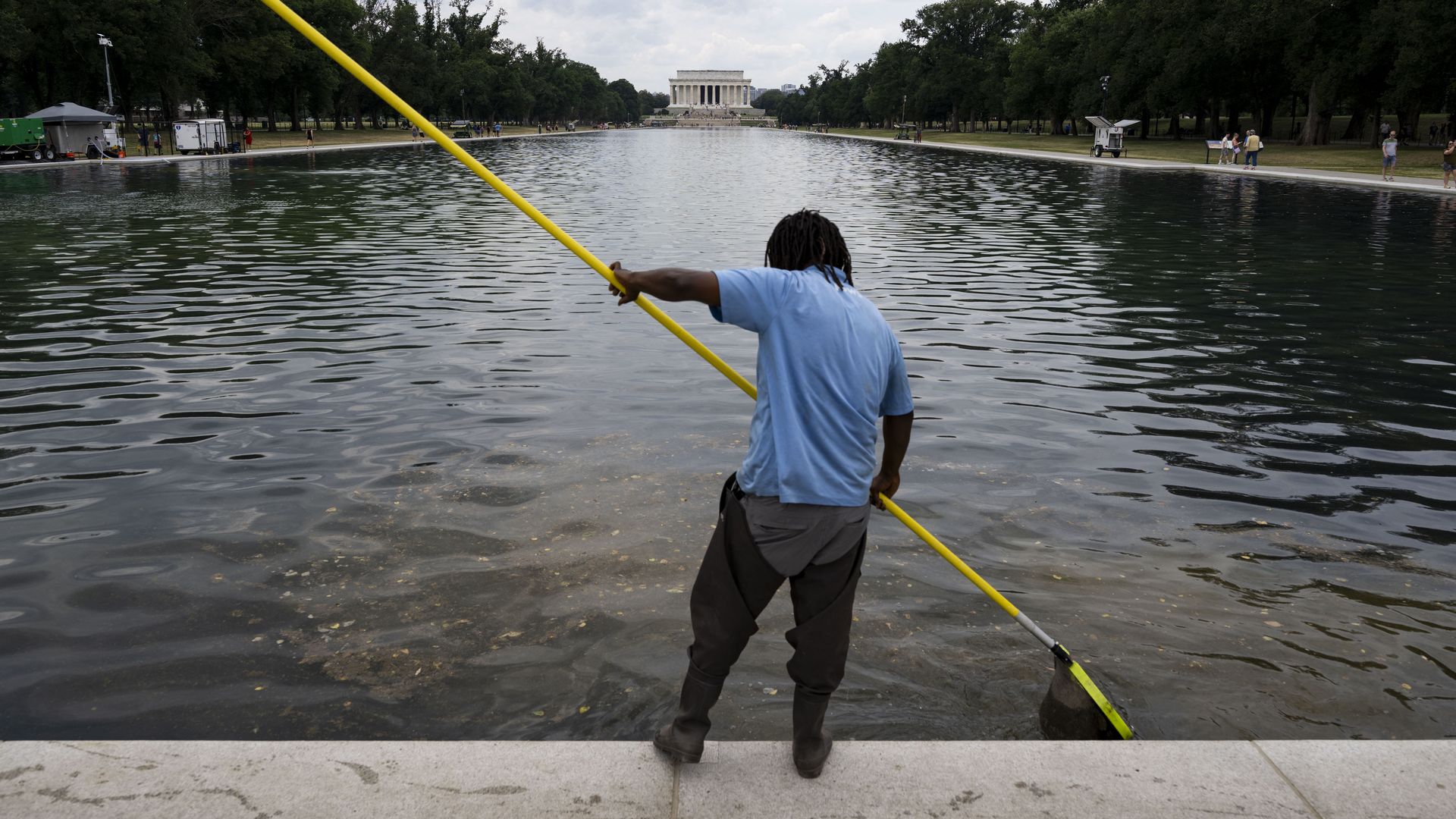 A worker is cleaning the Reflecting Pool