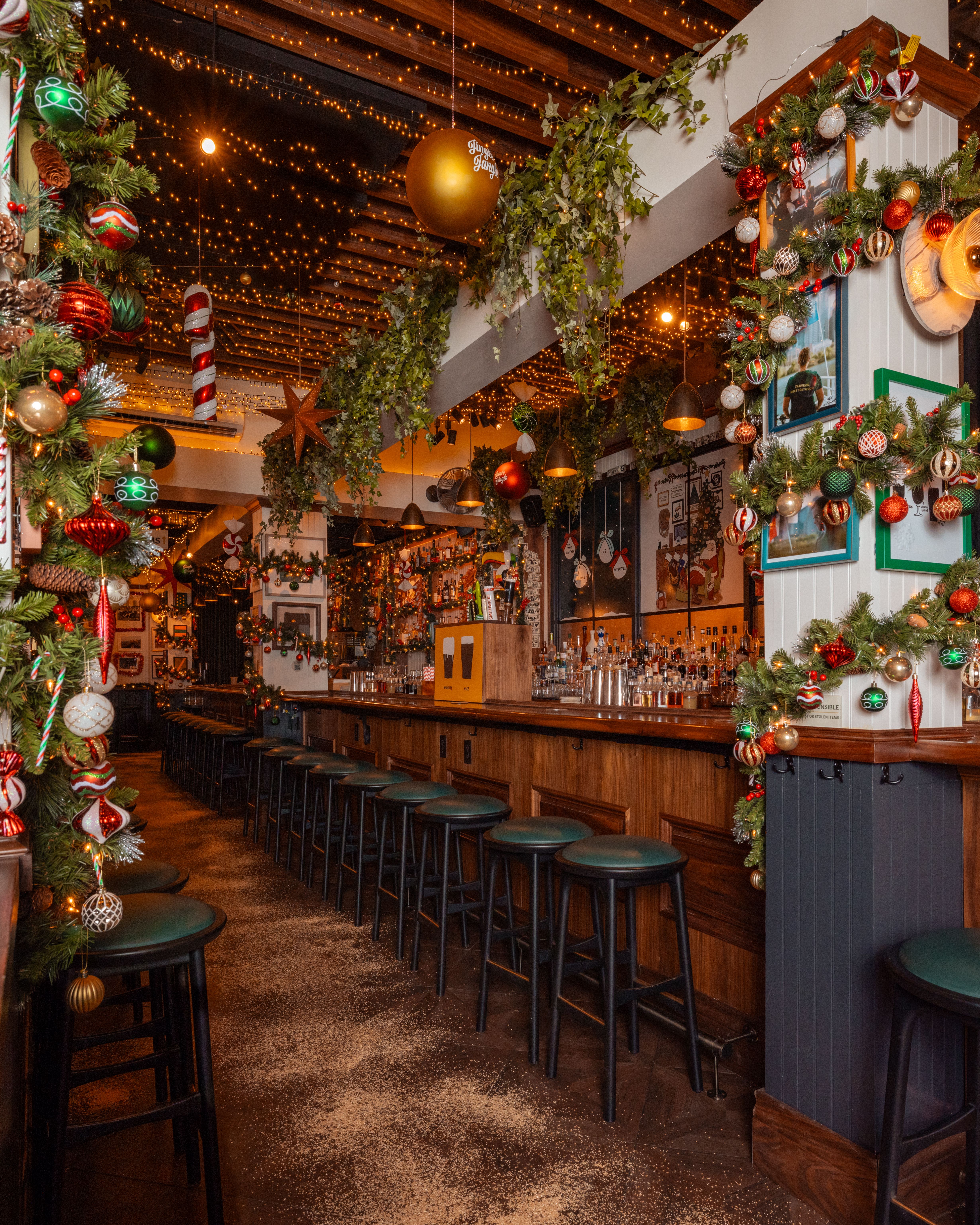 a photo of the interior of a bar with christmas decorations.