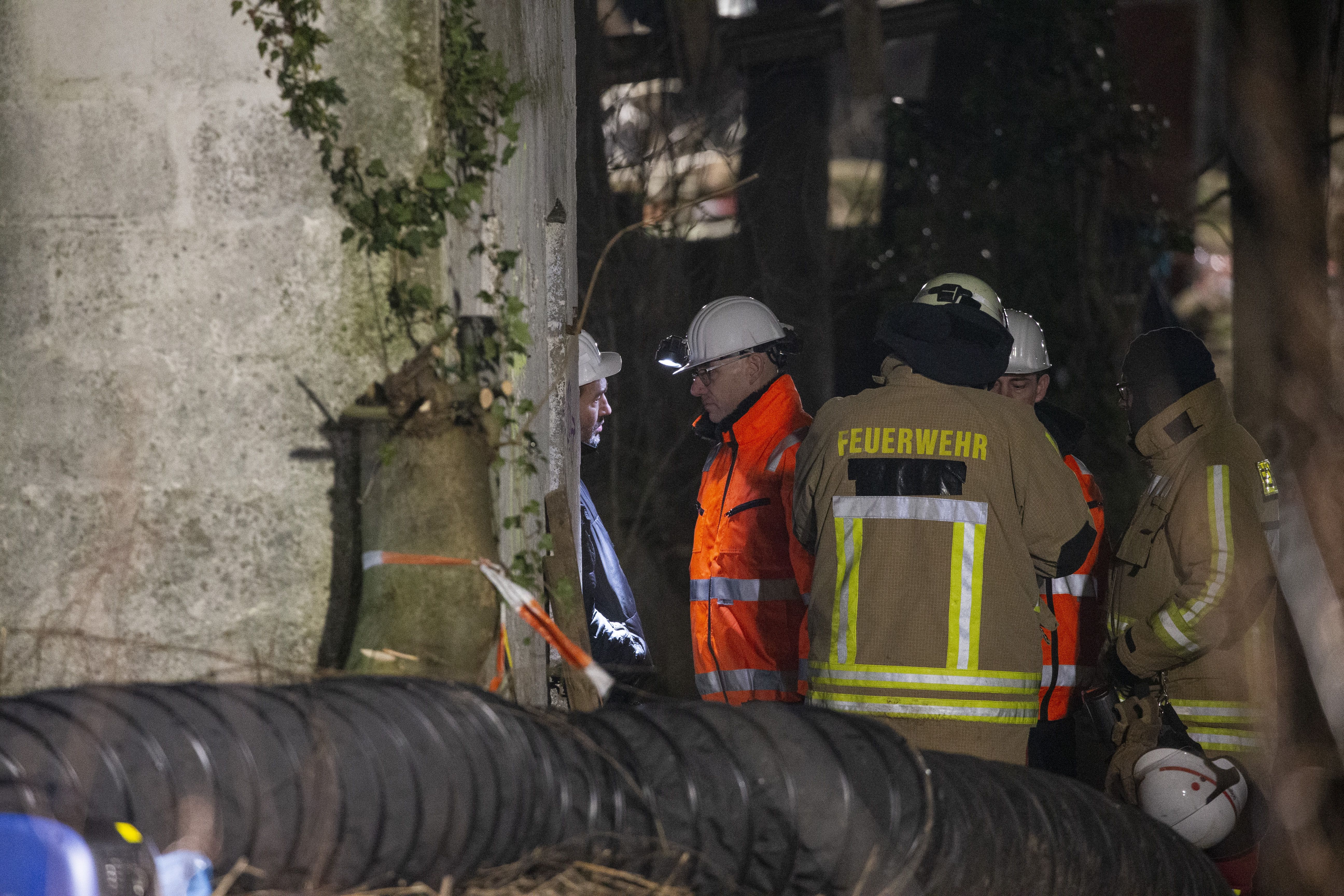 Police, fire department and RWE specialists stand in front of the entrance to a building at a mine site in western Germany Jan. 15.