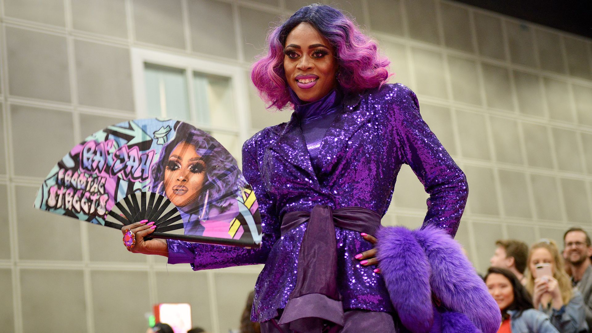 Ra'Jah O'Hara in a purple outfit with a fan reading "Ra'Jah from the streets"