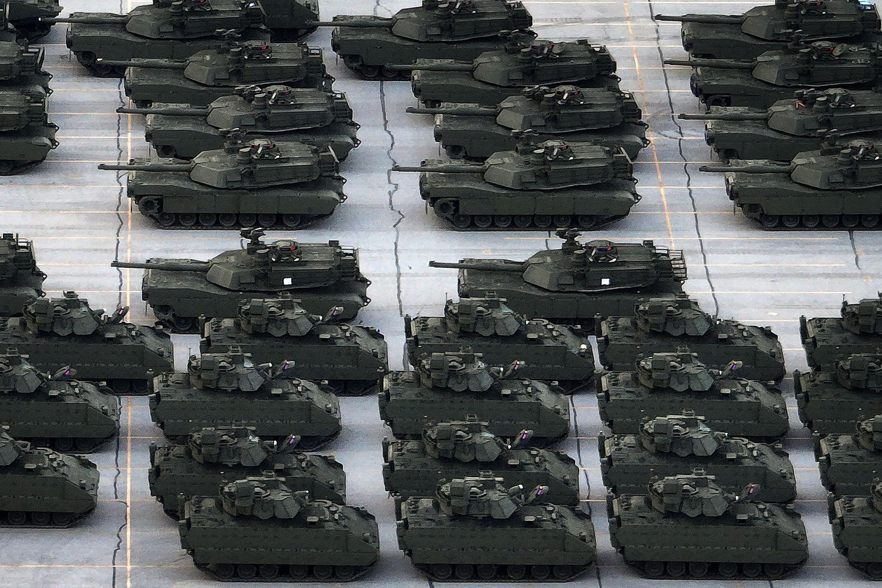 M1 Abrams tanks and Bradley Fighting Vehicles are loaded onto tractor-trailer trucks in a Maryland rail yard yesterday.