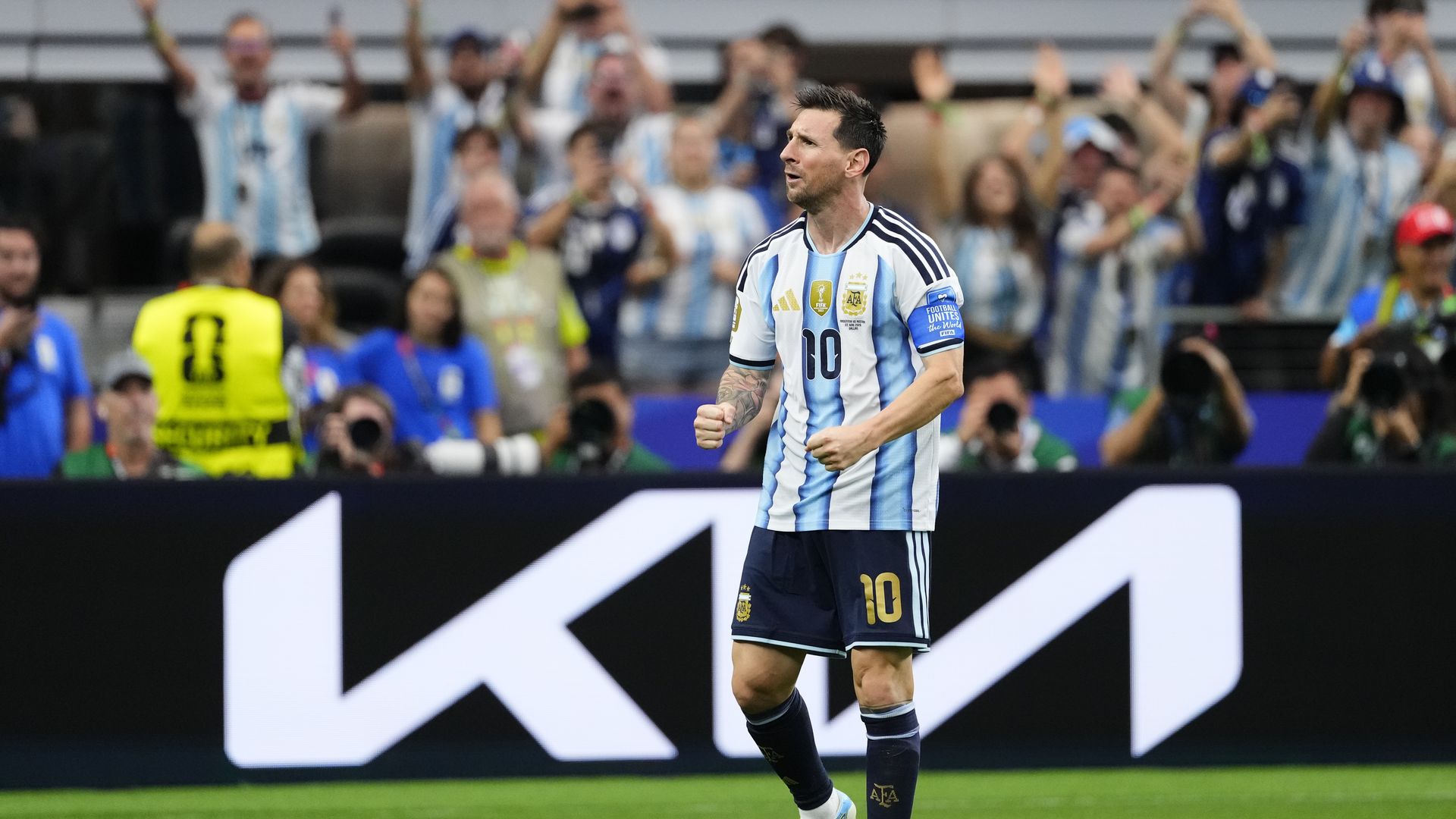 Lionel Messi stands on the field after scoring his history-making goal at Dallas Stadium.