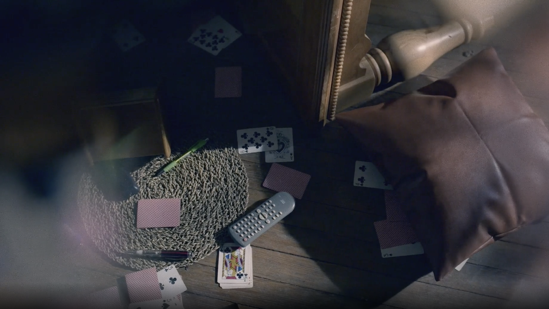 A living room scene disrupted by turned over furniture.