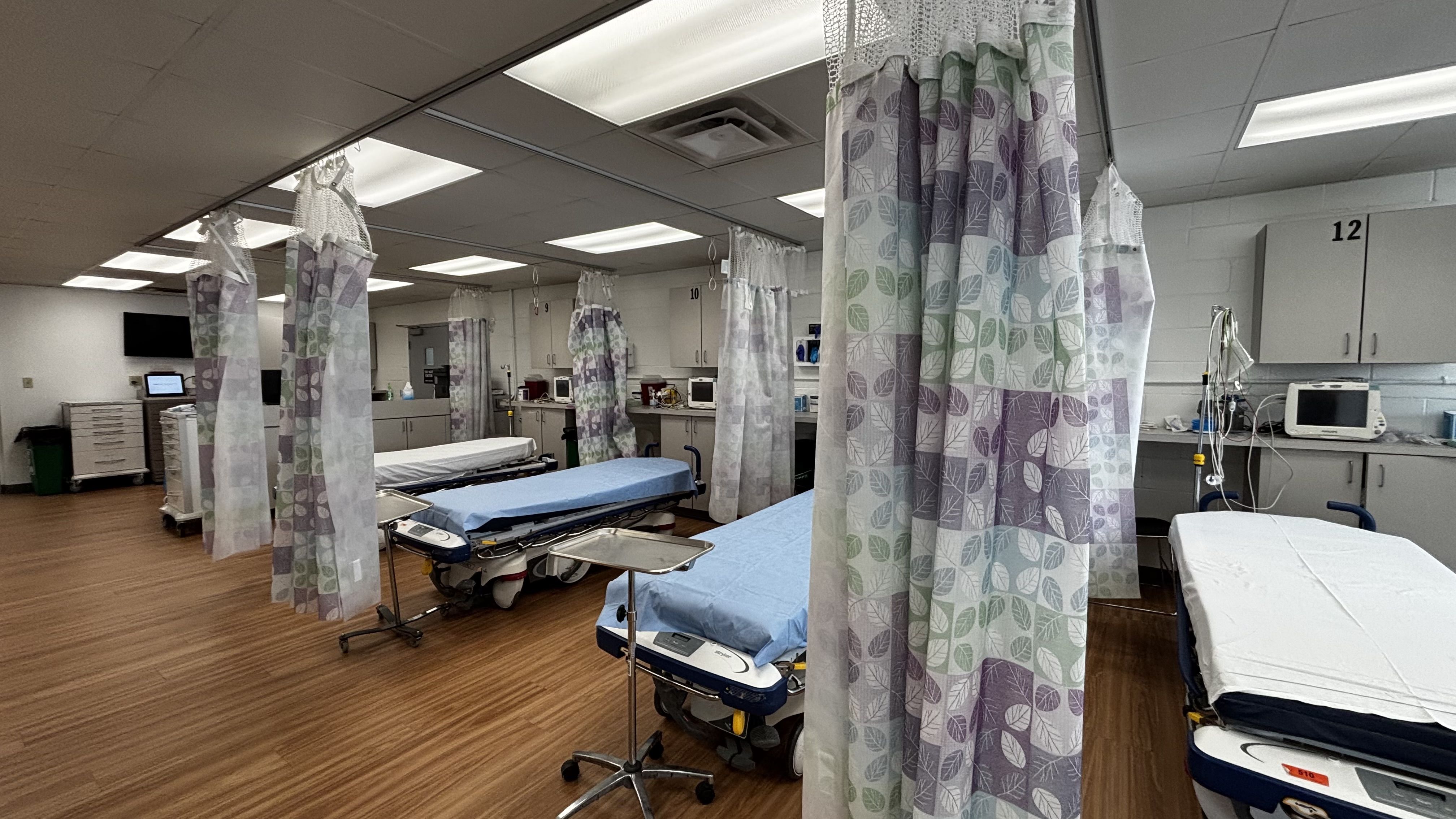 A row of beds in an emergency room