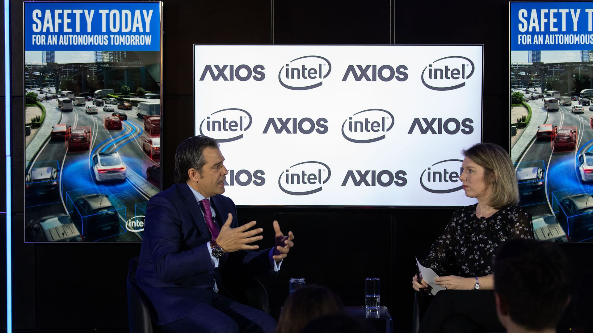 Man and woman sit on stage