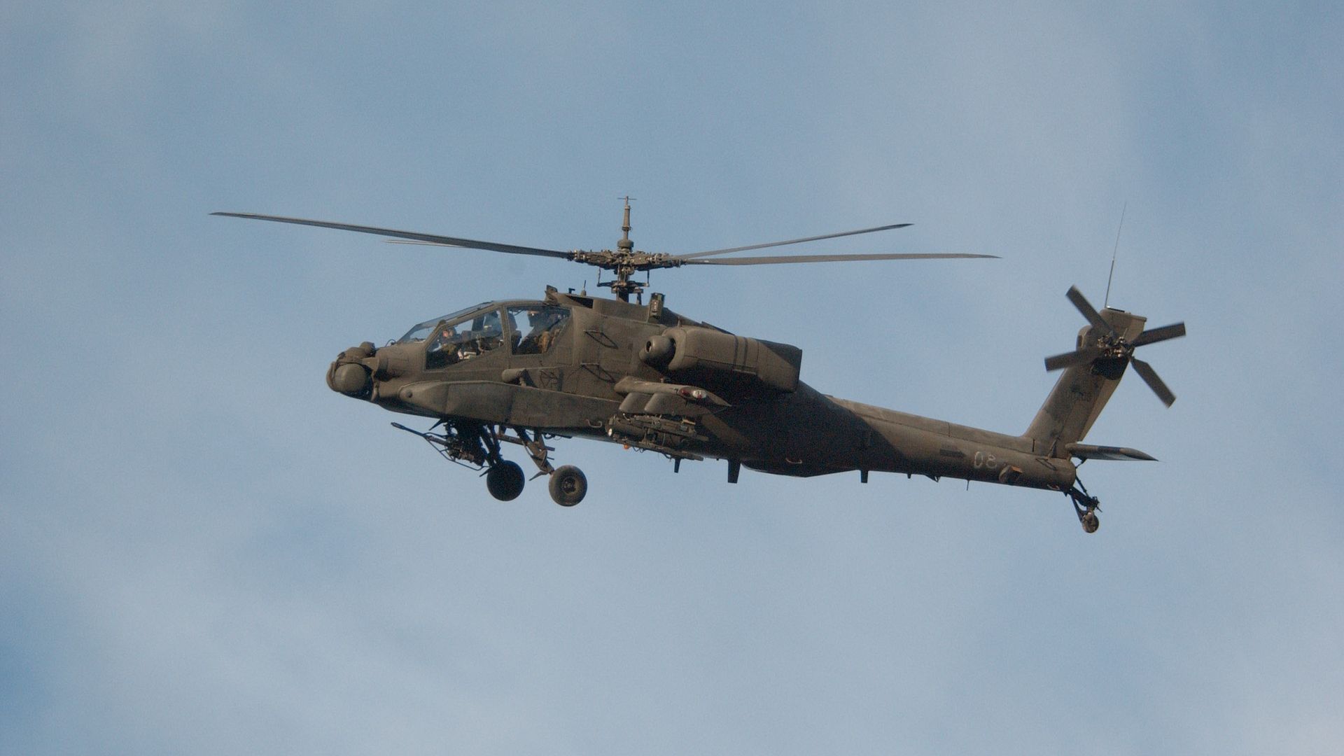 US Army soldiers flying an Apache helicopter at the Joint Readiness Training Center. 