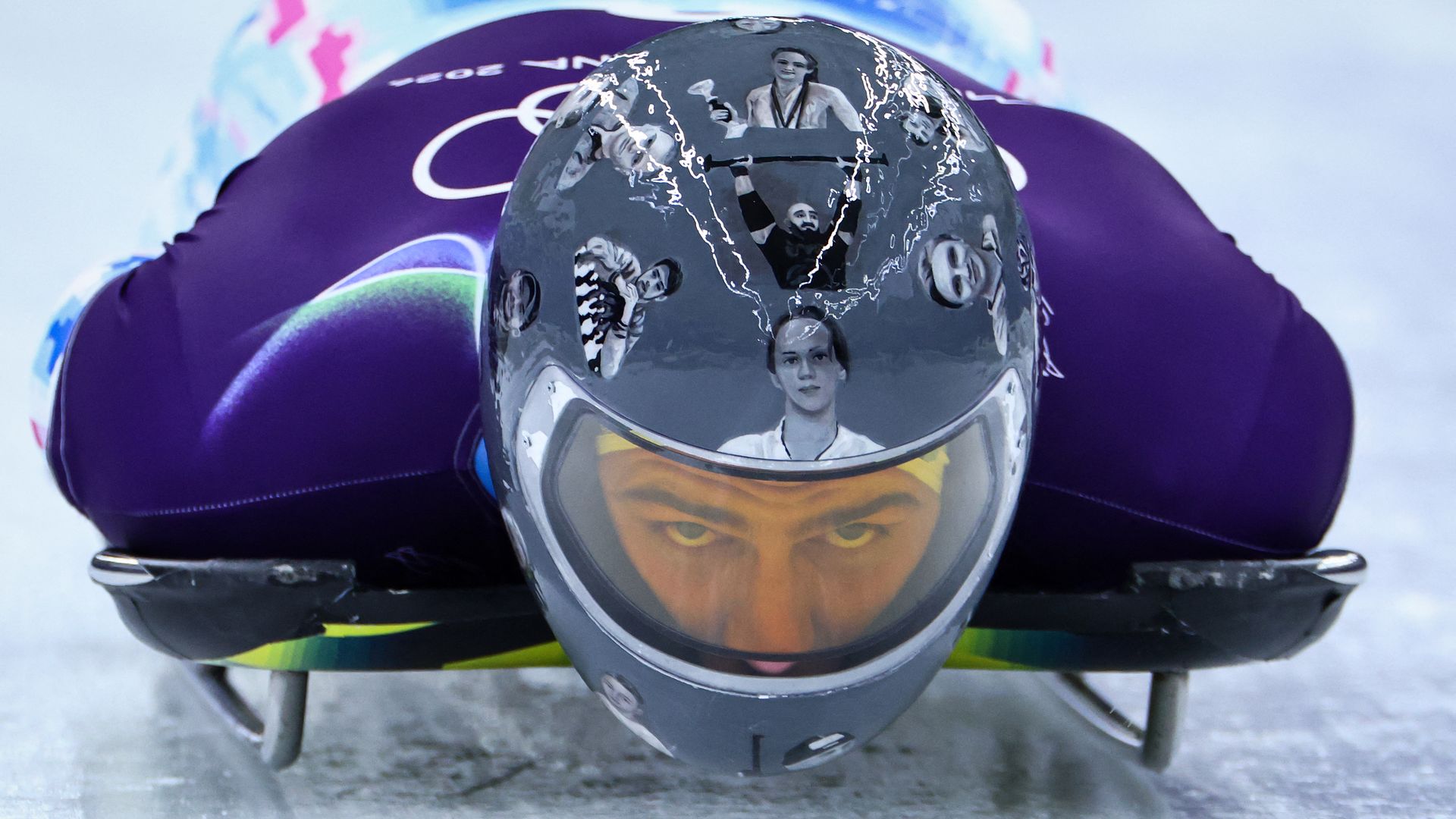 Ukrainian skeleton racer Vladyslav Heraskevych, during an Olympic training run on Monday wearing a helmet of athletes killed in the war with Russia.