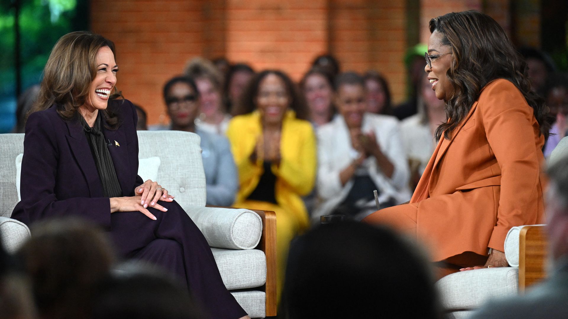 Vice President and Democratic presidential candidate Kamala Harris (L) joins US television producer Oprah Winfrey at a 'Unite for America' live streaming rally in Farmington Hills, Michigan, on September 19, 2024. 