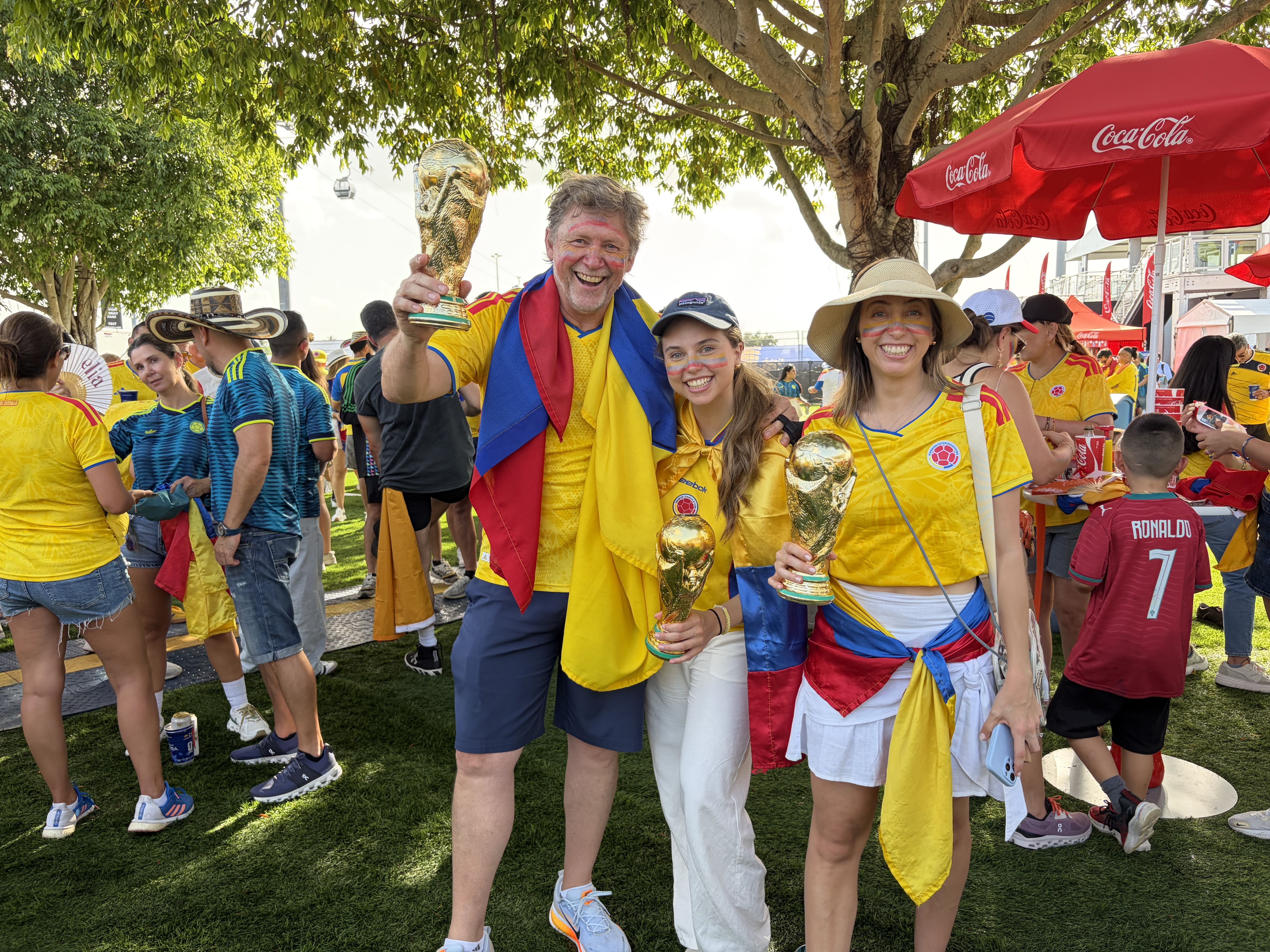 Colombia fans pose for a photo with novelty world cup trophies. 