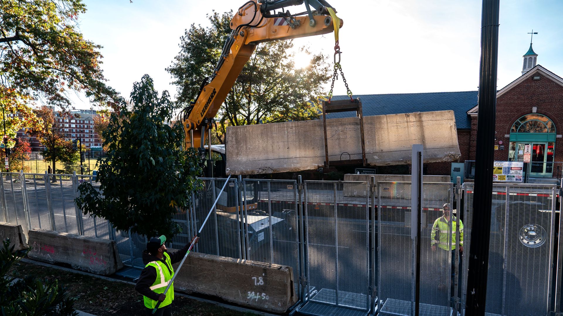 Crews move concrete barriers outside of Howard University.
