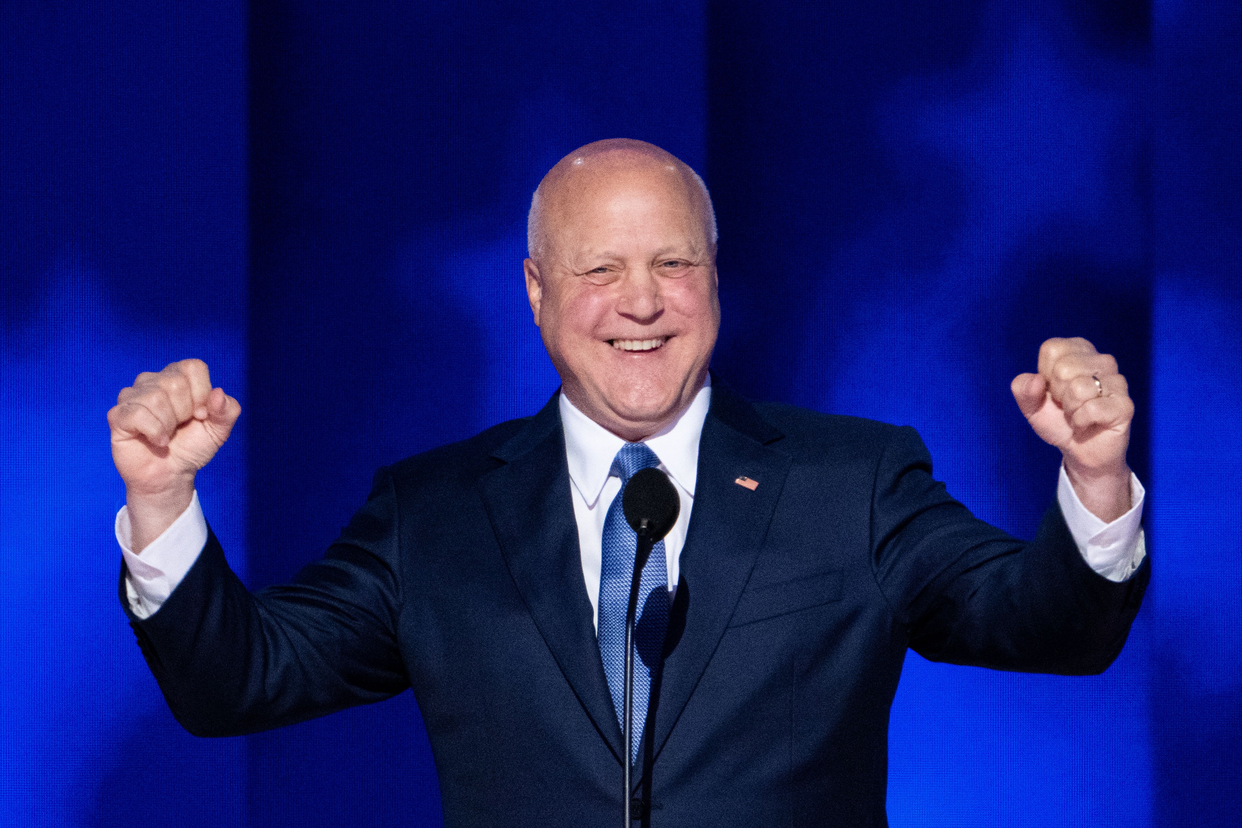Photo shows Mitch Landrieu making a victorious gesture.