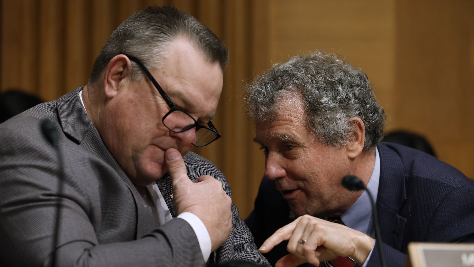 Senate Banking, Housing and Urban Affairs Committee Chairman Sherrod Brown (D-OH) (R) talks with committee member Sen. Jon Tester (D-MT) during a hearing about the Consumer Financial Protection Bureau in the Dirksen Senate Office Building on Capitol Hill on December 15, 2022 in Washington, DC.