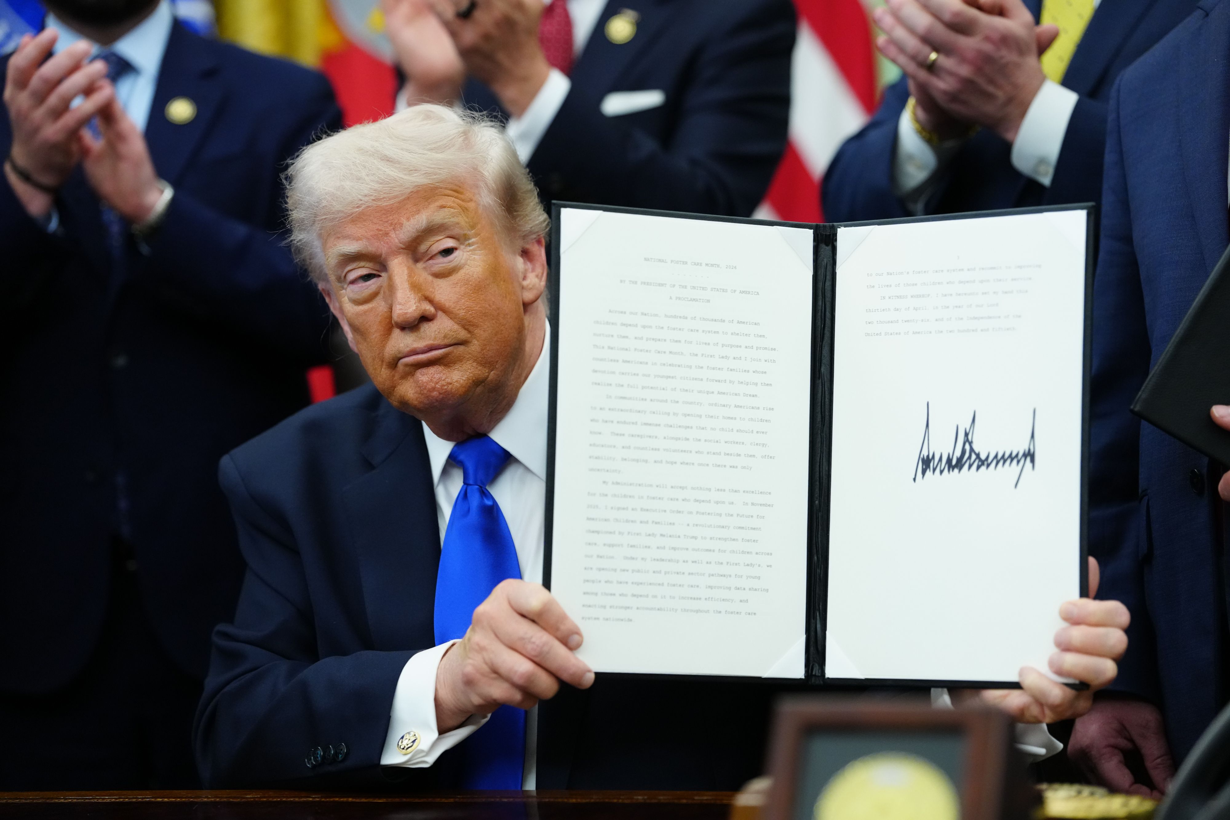 Trump signs an executive order in the Oval Office