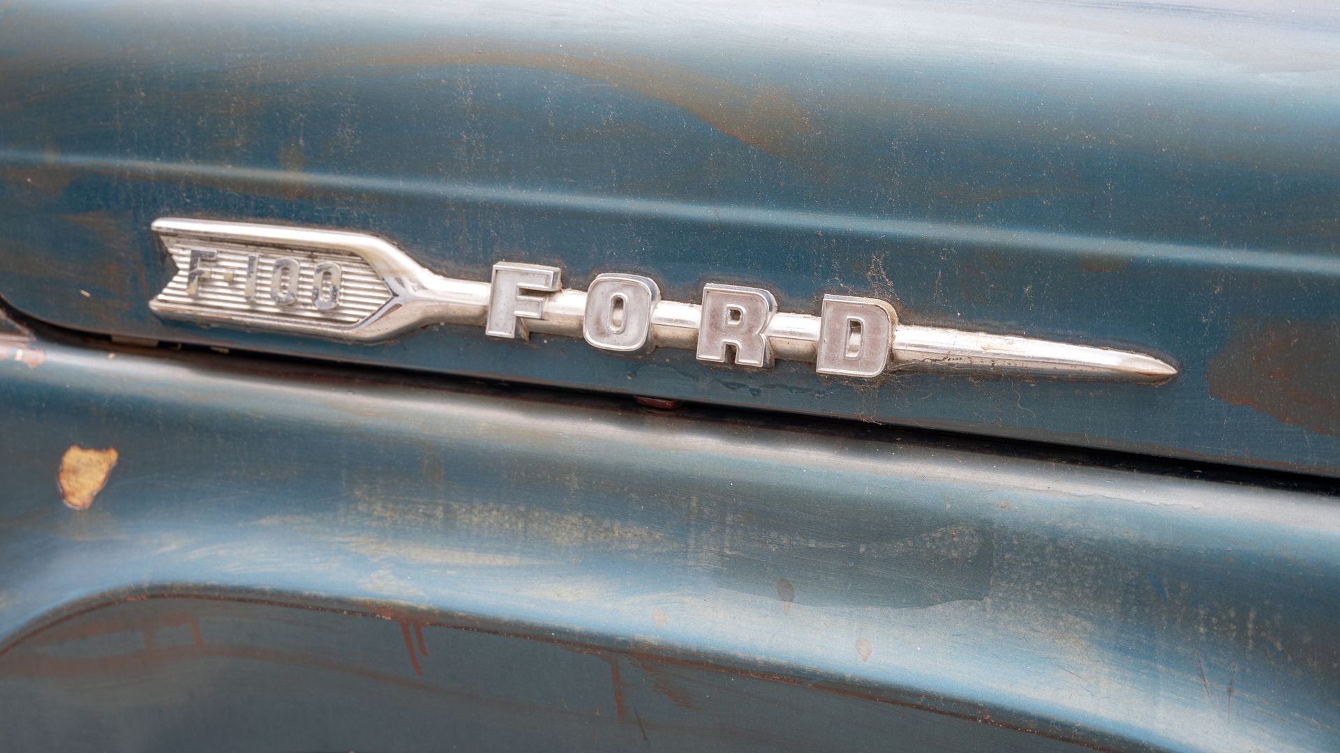 A Ford F-150 badge on a classic pickup truck. 