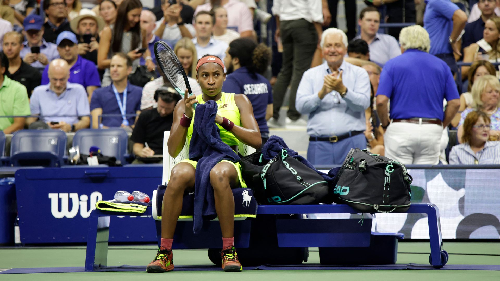  USA's Coco Gauff sits as the match is delayed by a protestor in the crowd during the US Open tennis tournament women's singles semi-finals match against Czech Republic's Karolina Muchova at the USTA Billie Jean King National Tennis Center in New York City, on September 7, 2023.