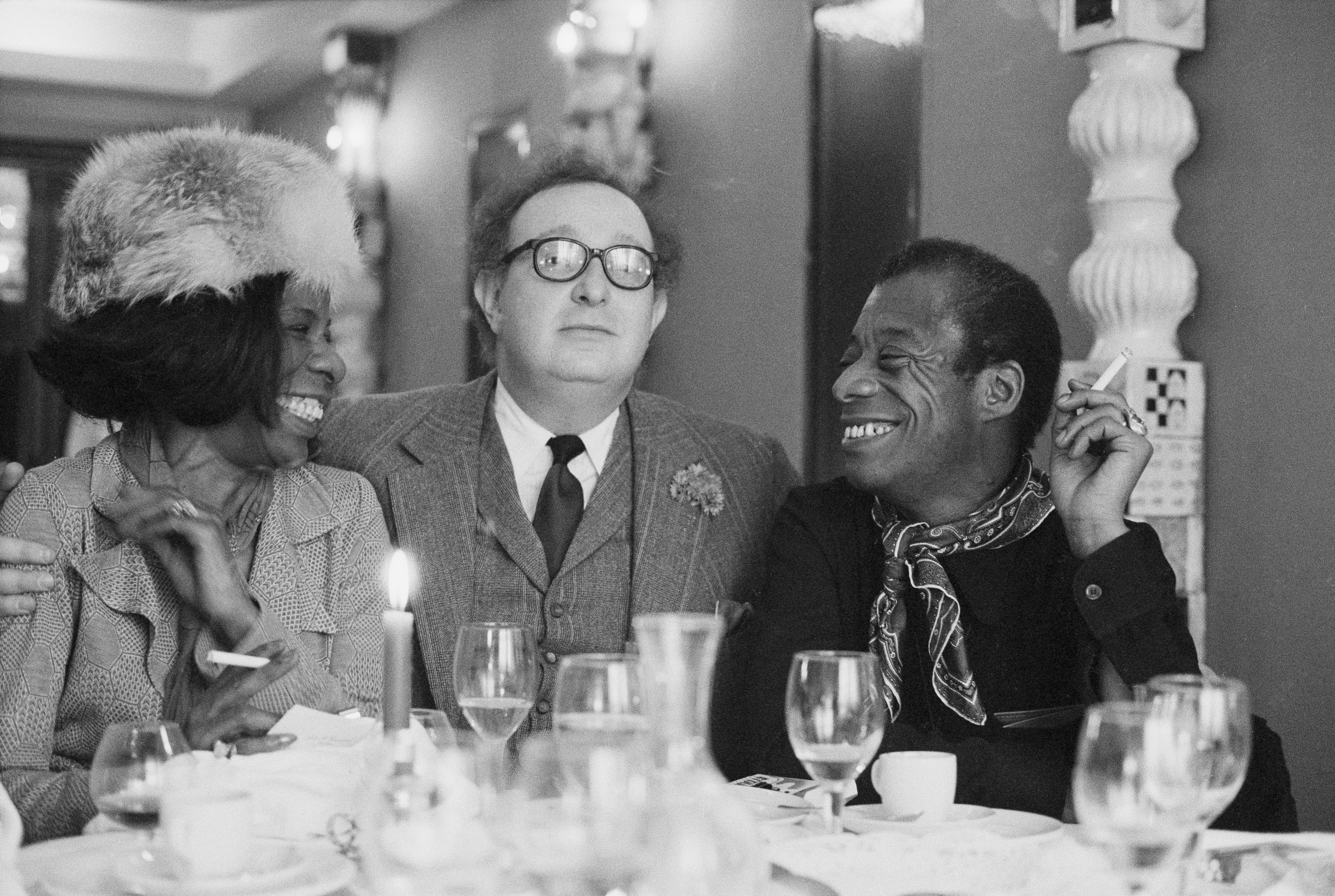 James Baldwin during a lunch in Paris with his literary agent and a friend.