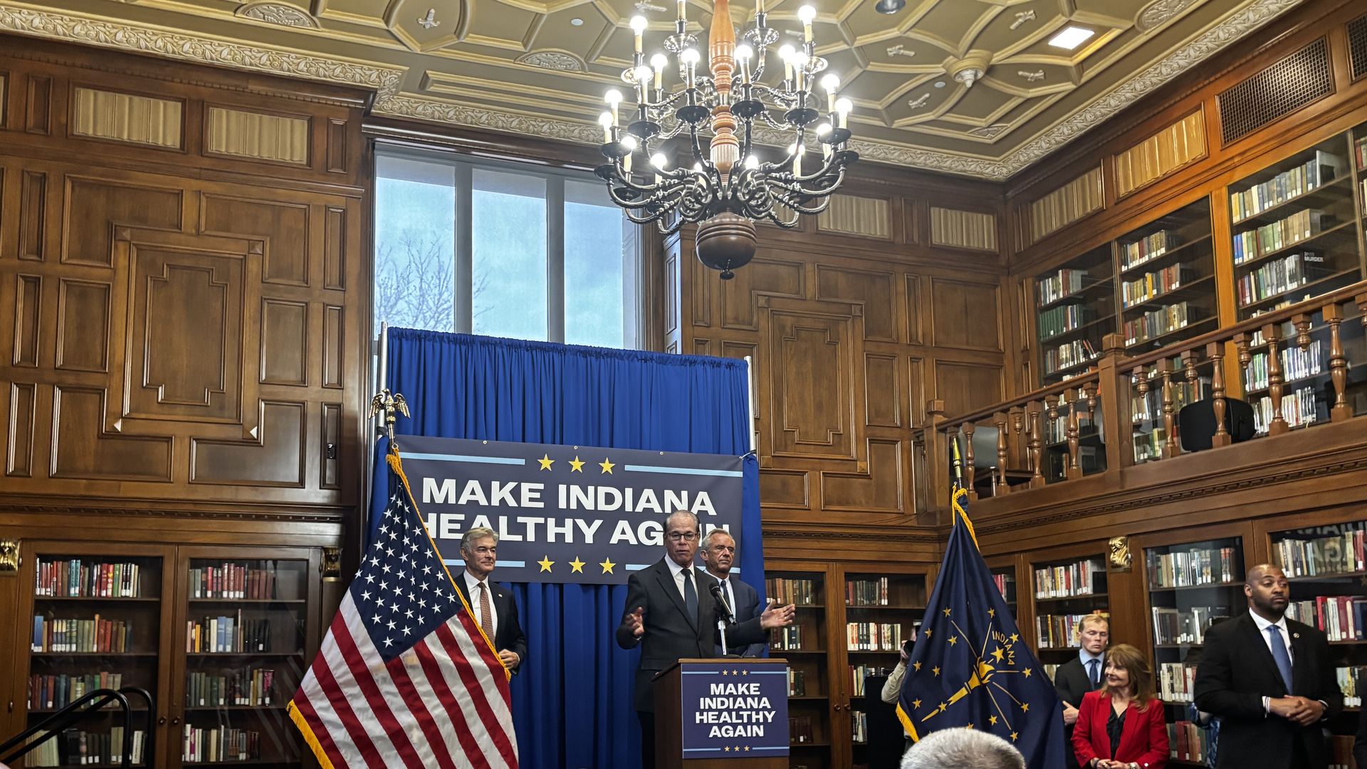 Gov. Mike Braun at a podium in a library