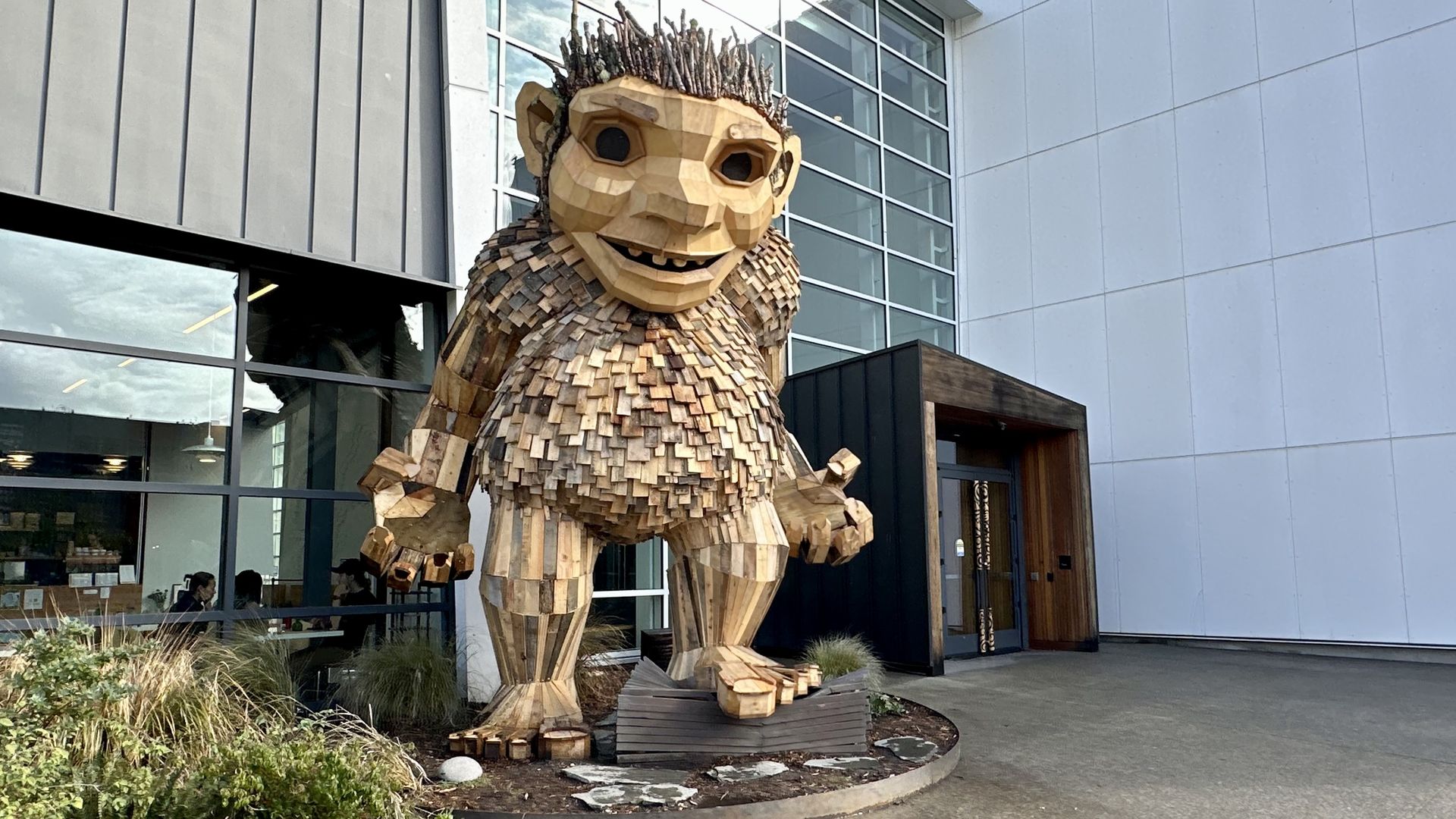 A troll made of wood and recycled materials stands far taller than the entrance of the National Nordic Museum in Ballard.