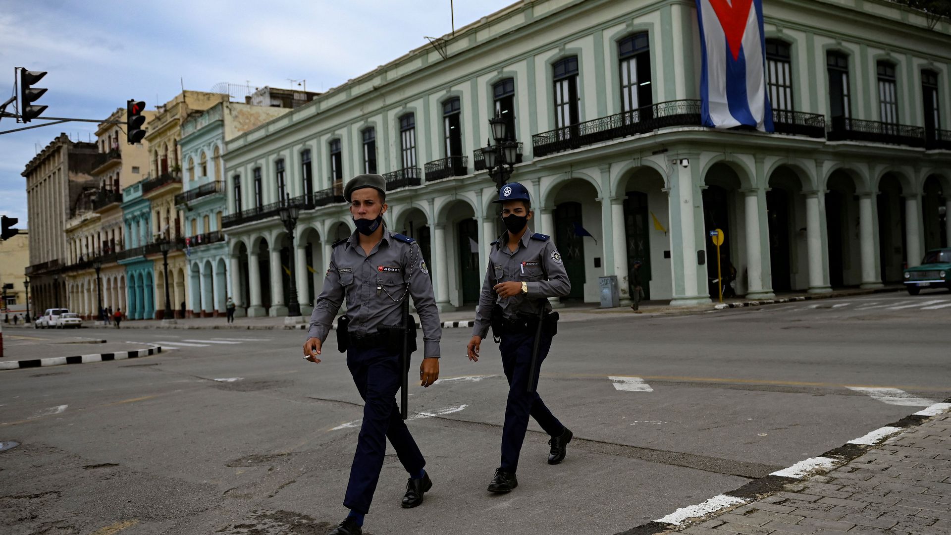 Police officers walk along a street in Havana, Cuba, November 15. On the day of the scheduled protest, streets are quiet after a government crackdown.