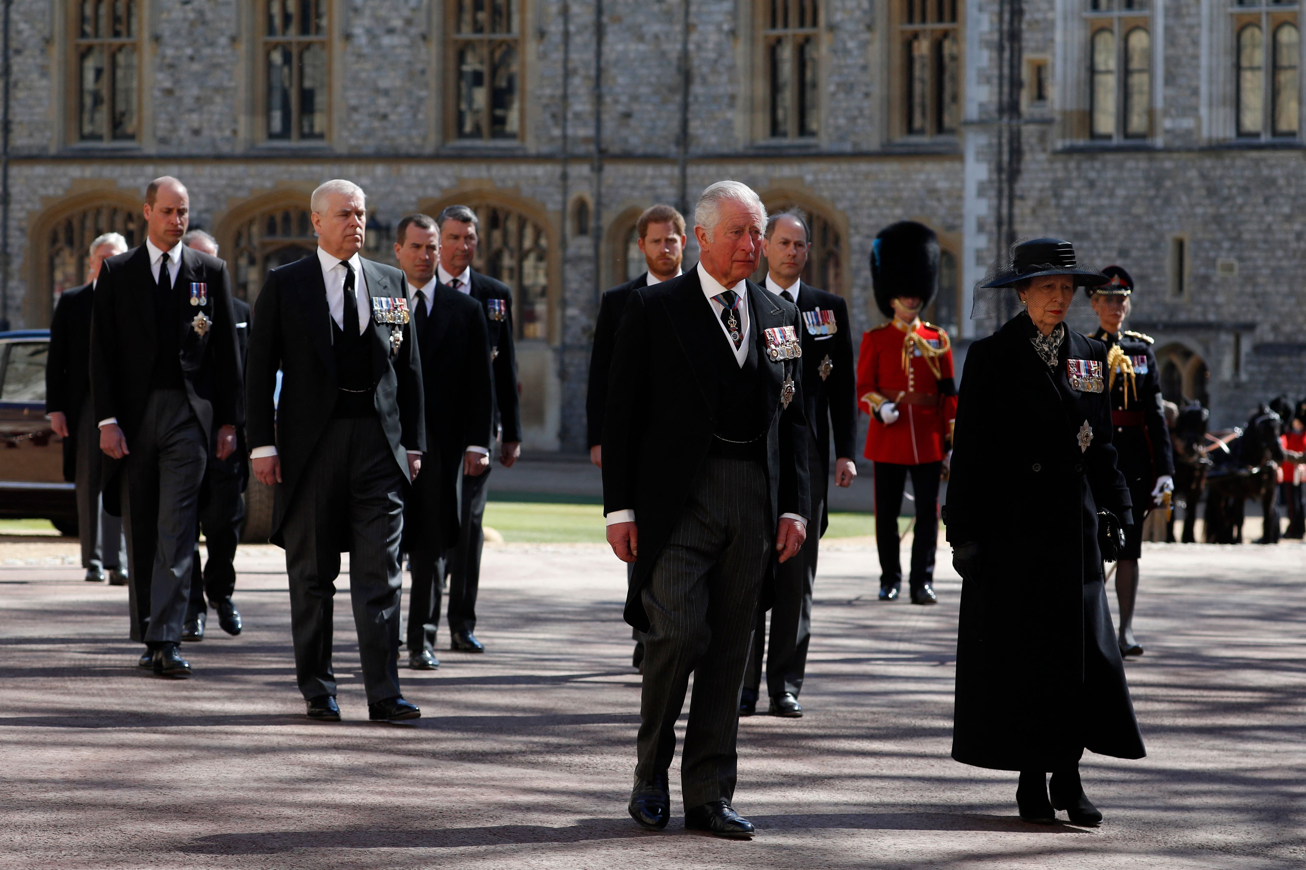 Picture of royal family members walking behind the land rover that carries Prince Philip's coffin