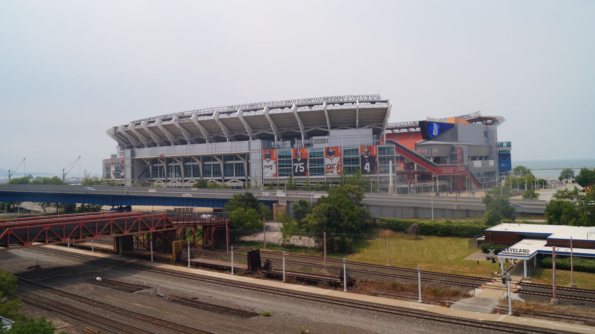 A portrait view of Cleveland Browns stadium, with an overcast sky and Lake Erie in the background