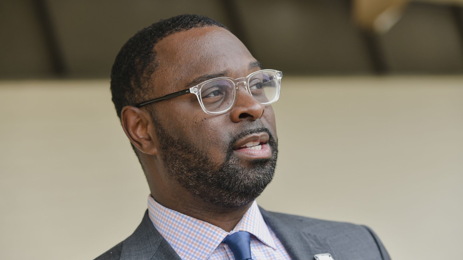 A photo of Memphis Mayor Paul Young from the shoulders up wearing a gray suit and clear glasses.