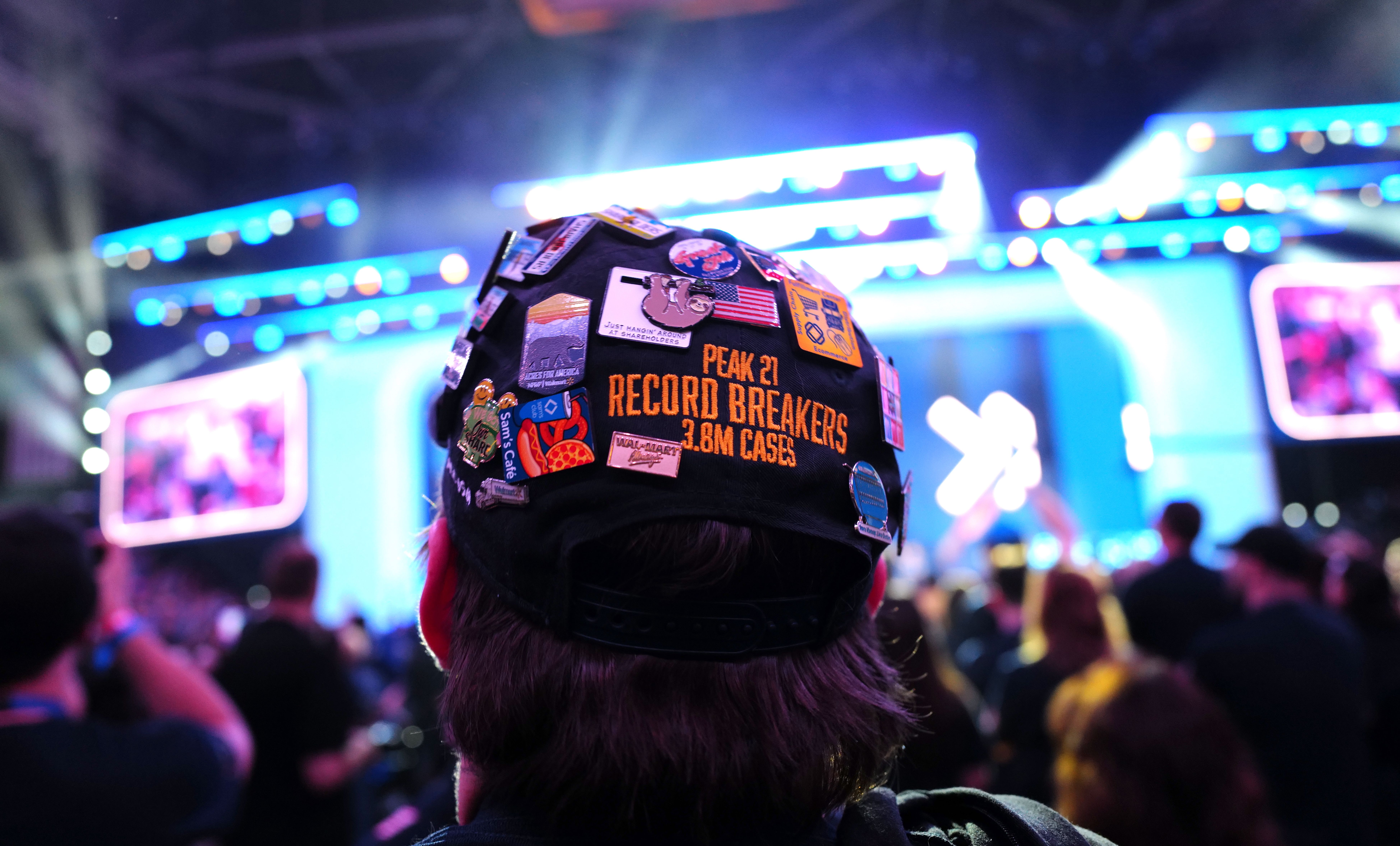A Walmart employee showed off flair with buttons in a hat. 