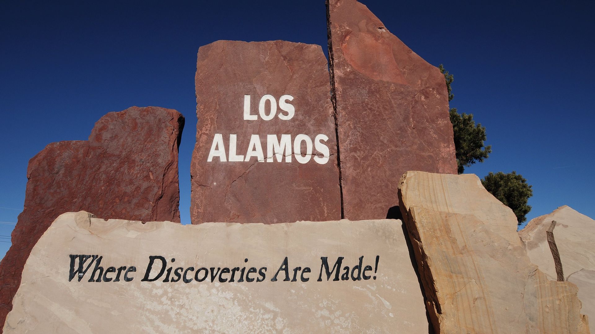 A stone sign welcomes motorists to Los Alamos, New Mexico, home to the Los Alamos National Laboratory established in 1943 as part of the Manhattan Project.