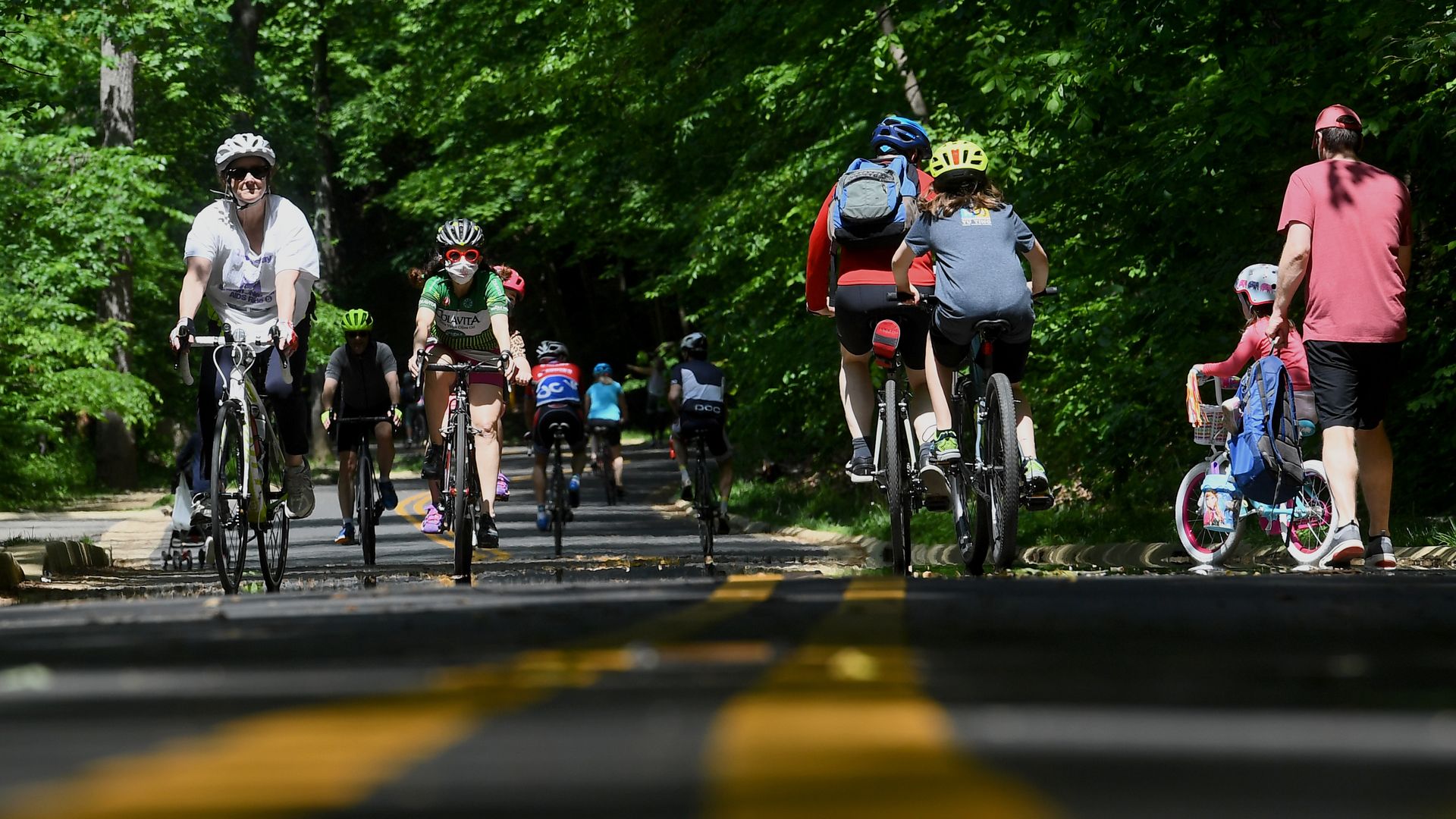 People ride bikes on along Beach Drive in Rock Creek Park.