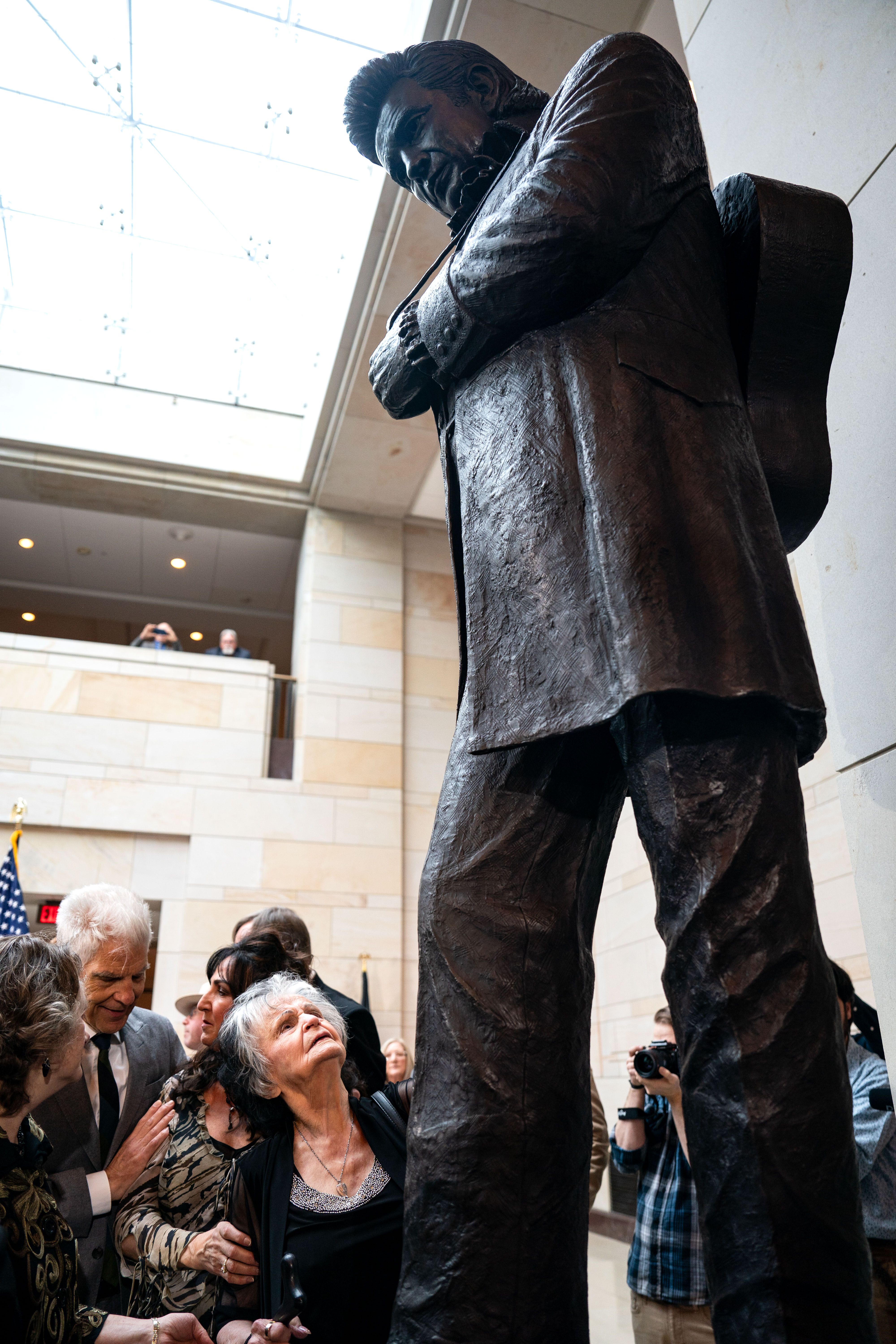 oanne Cash, sister of American singer-songwriter Johnny Cash reaches out to touch the statue of her late brother after it was unveiled in Emancipation Hall at the U.S. Capitol on September 24, 2024 in Washington, DC.
