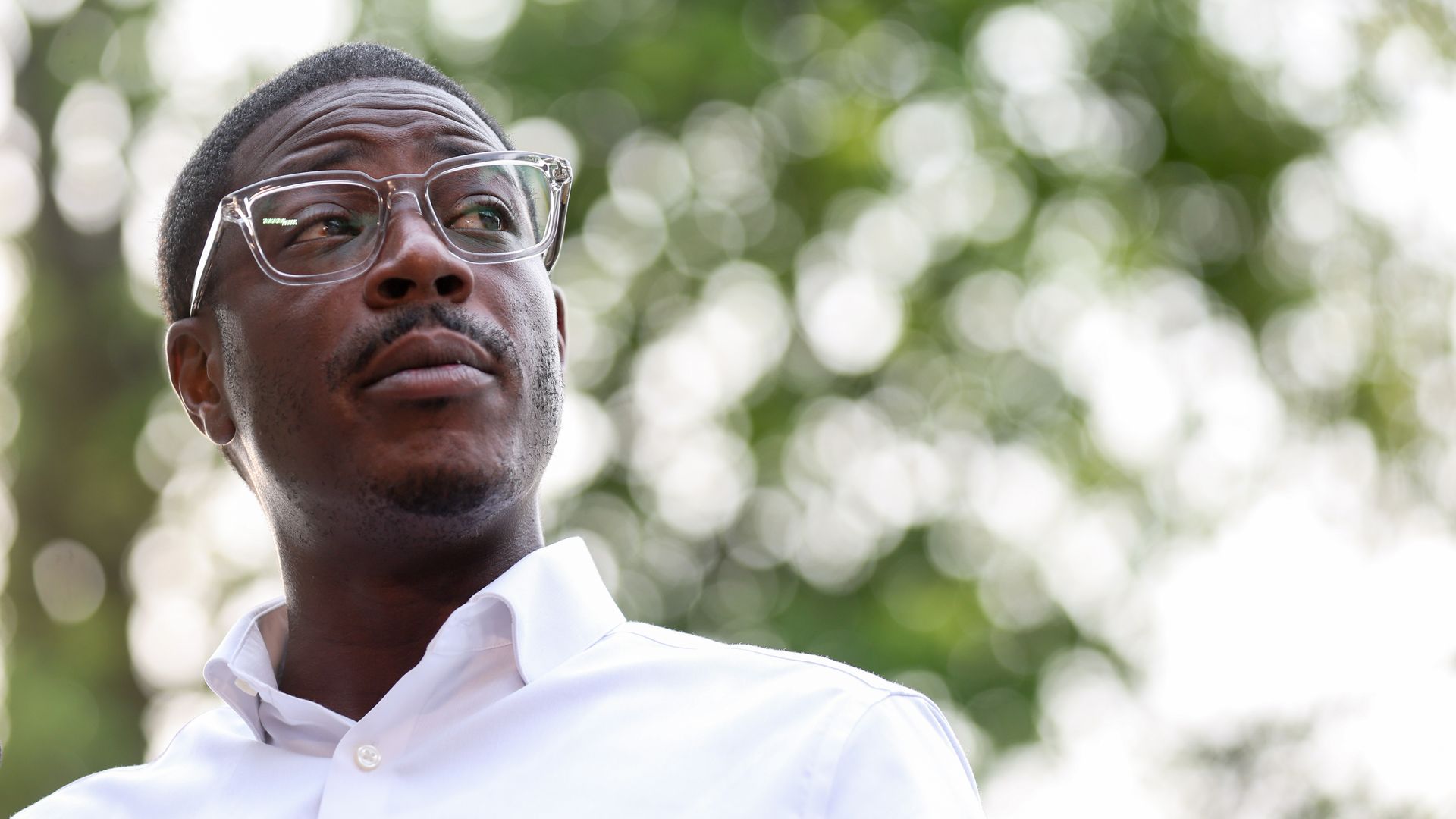 David Crowley, wearing glasses and a white shirt, stands outdoors in Milwaukee.