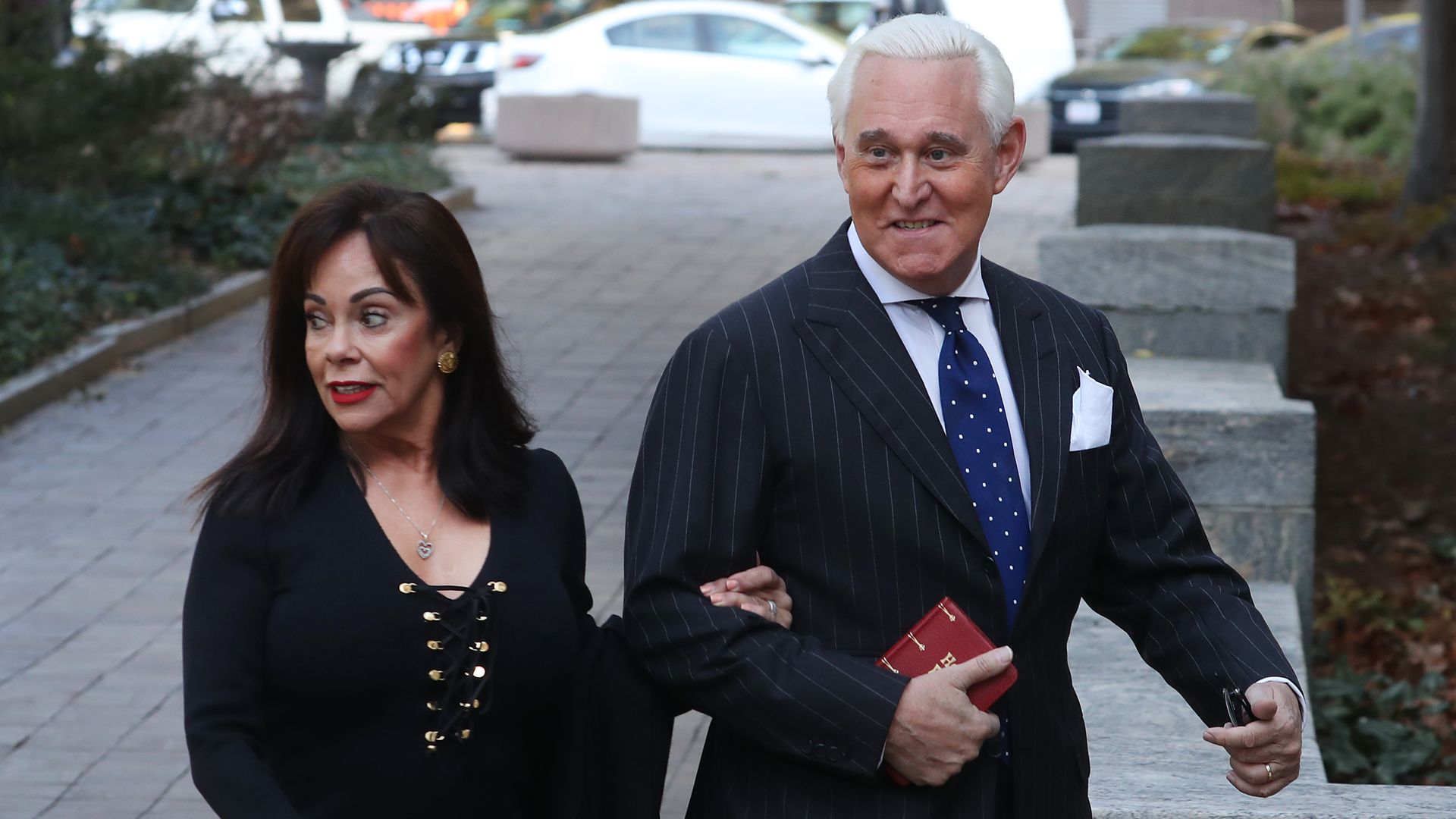 Roger stone walks into the courtroom with his wife.