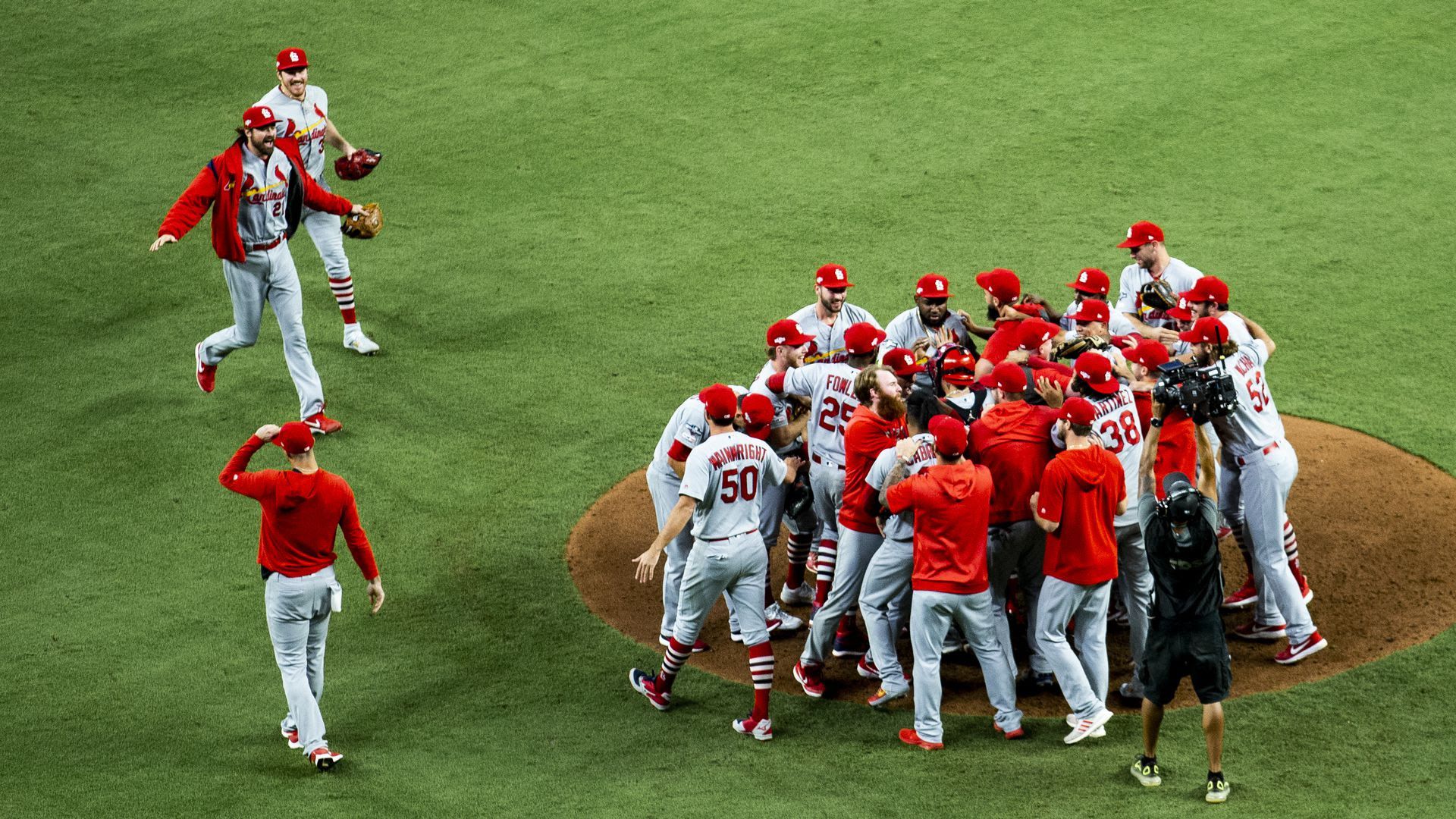 The Cardinals baseball team on the pitcher's mound