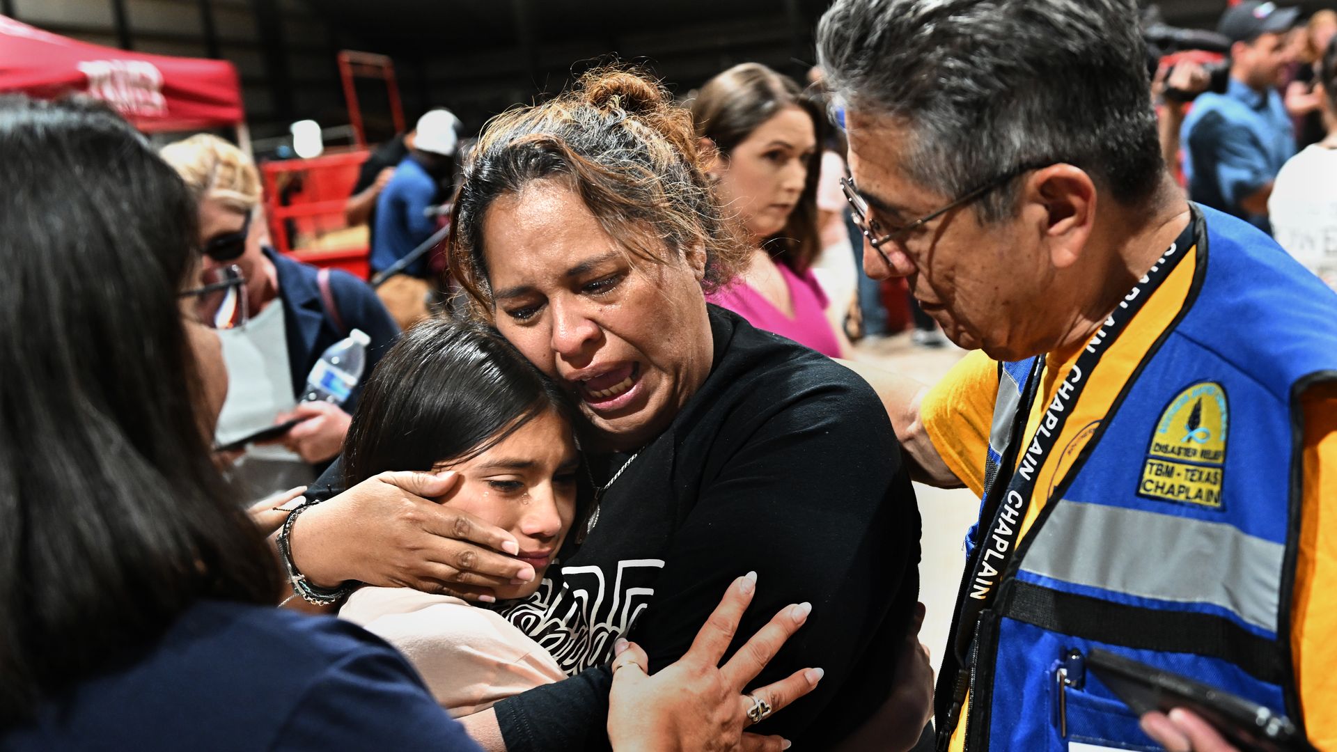 A fourth grade teacher at Robb Elementary school consoles her student after a vigil at the Uvalde County Fairplex in Texas Wednesday.