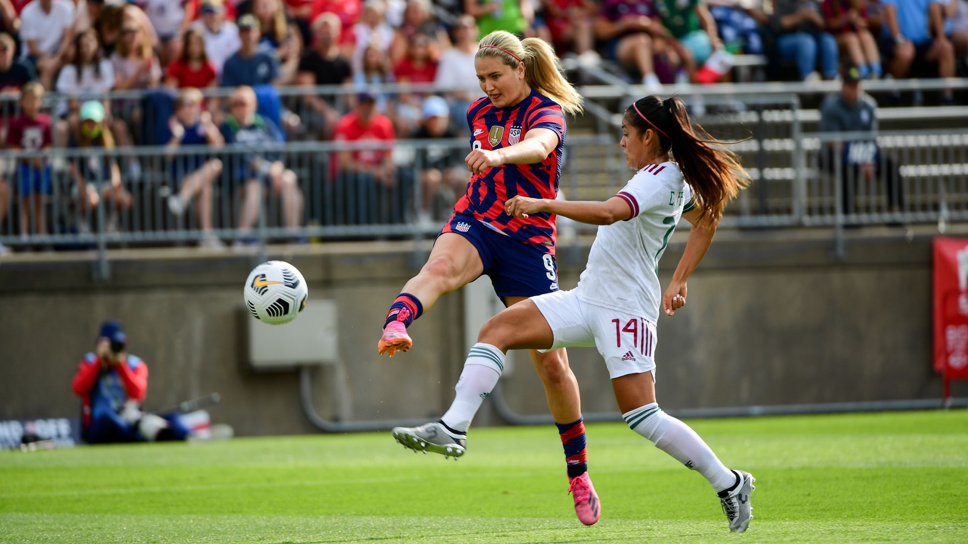 Lindsey Horan, left, scores a goal during a game against Mexico in July.