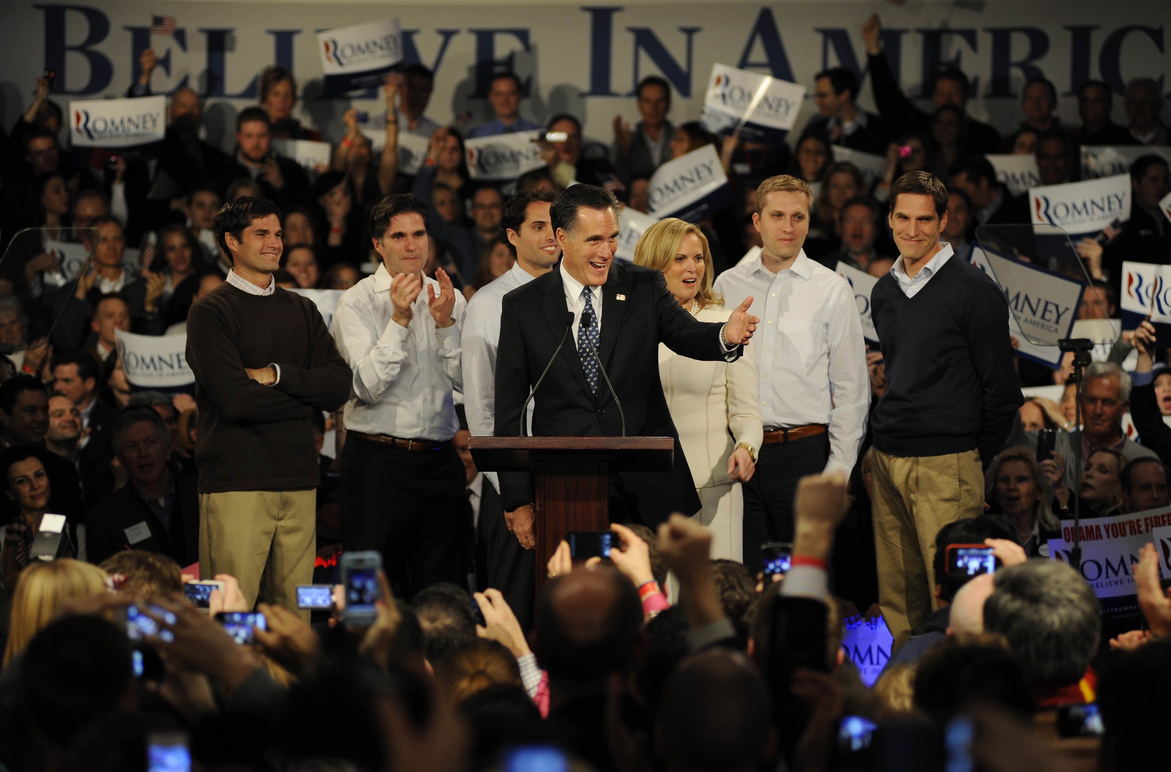 Mitt Romney with his family behind him at a campaign event