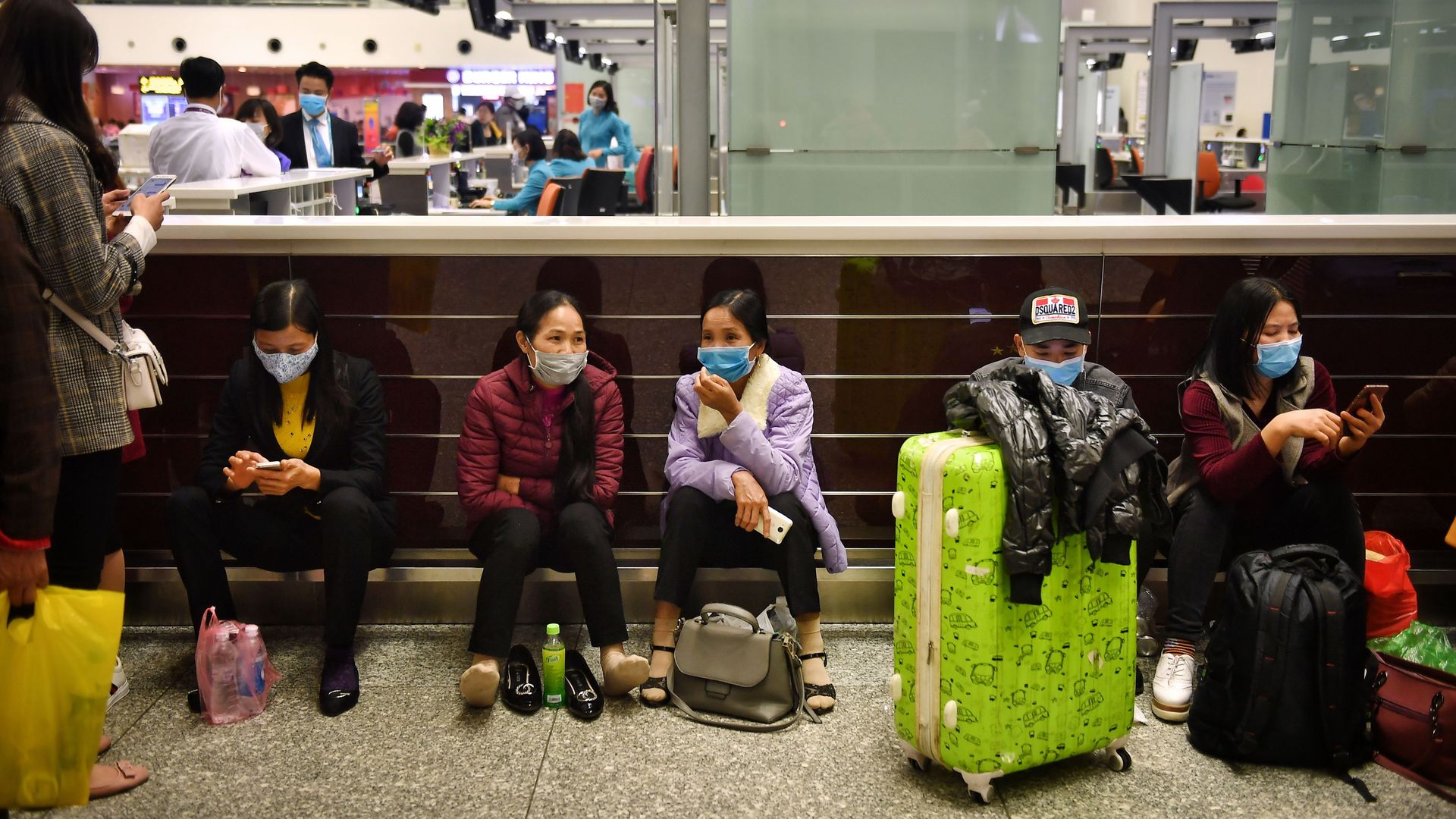 People sit in an airport.
