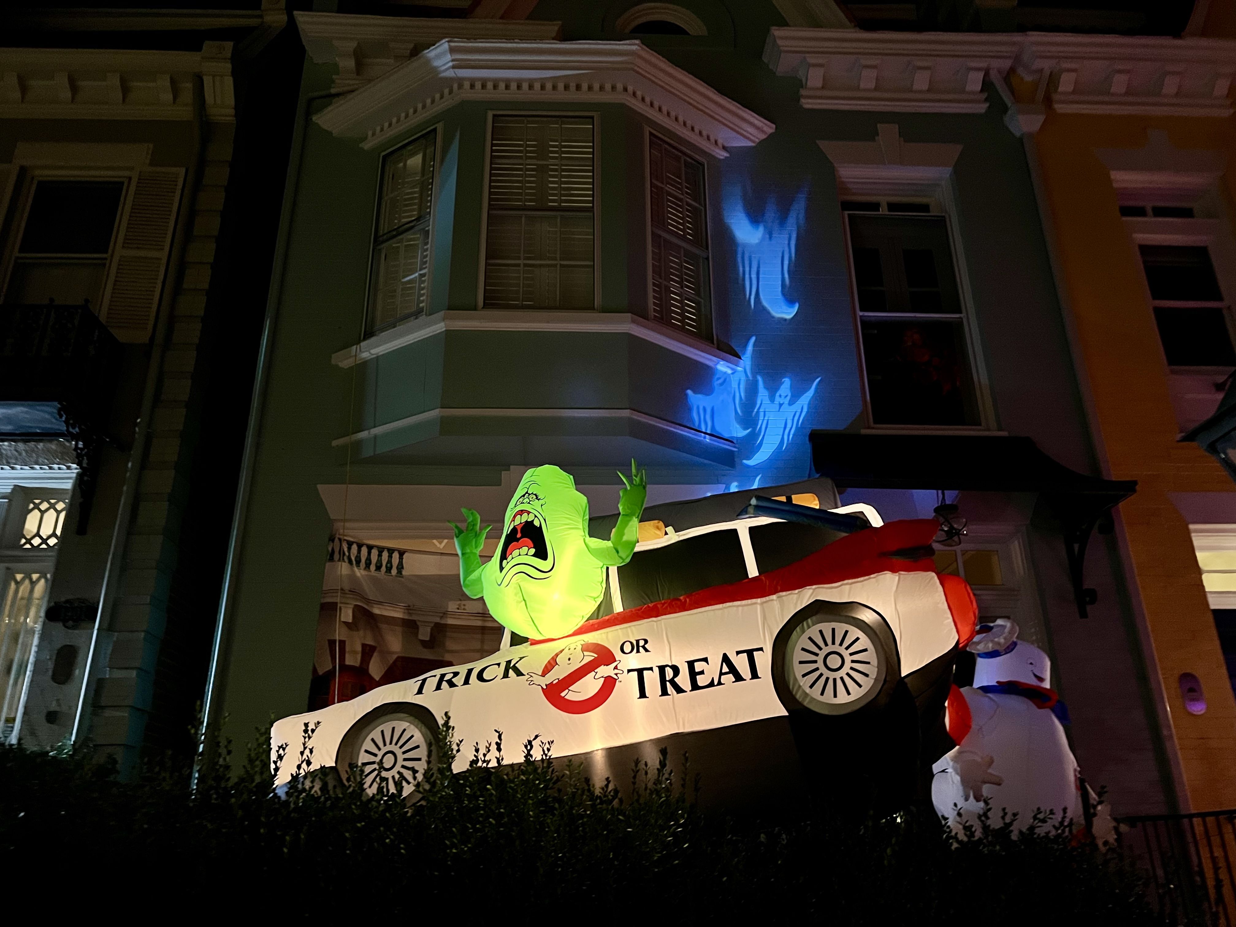 A ghostbusters car with an alien sticking out of it