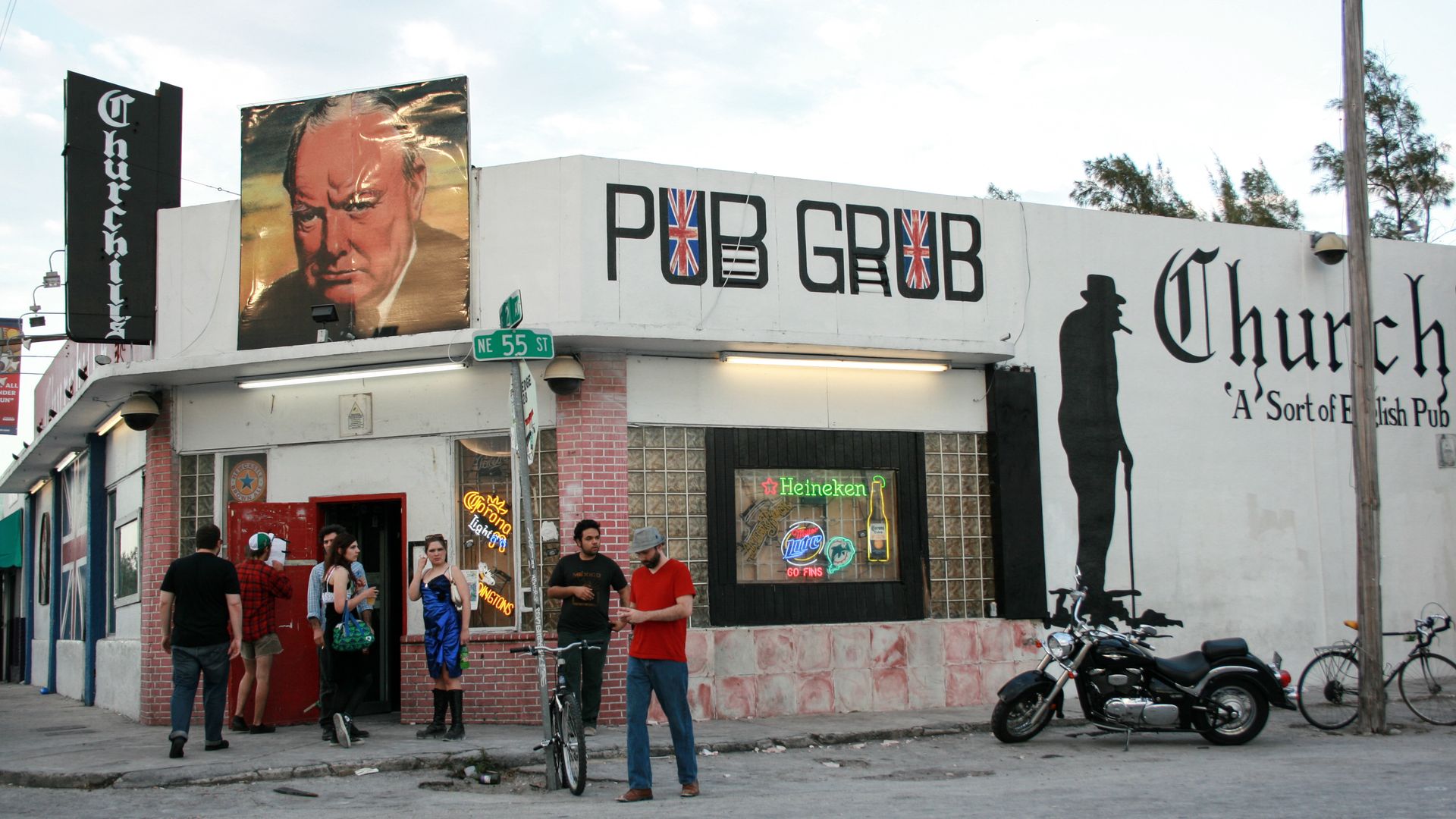 People stand outside a bar