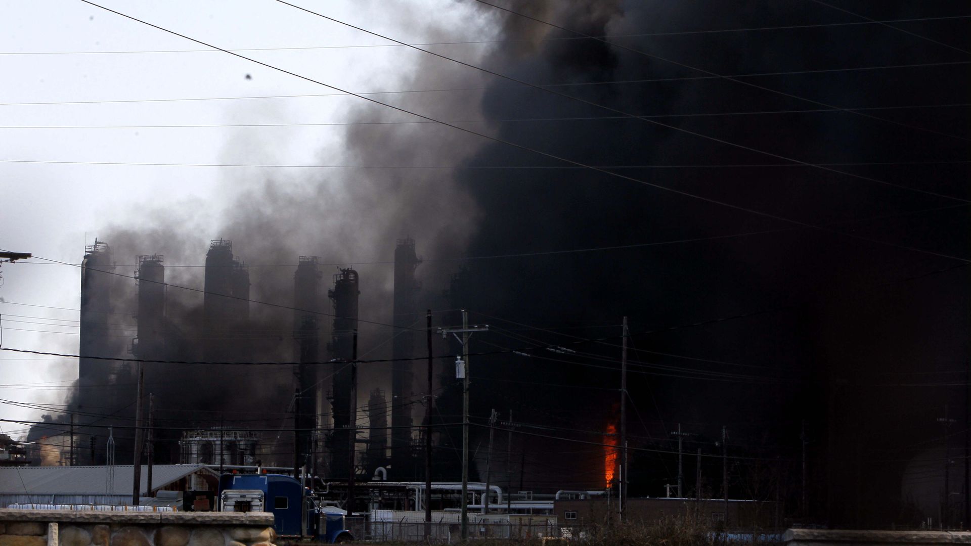 A chemical plant of TPC Group is shrouded by smoke as the fire continues in Port Neches, about 150 km east of downtown Houston, Texas