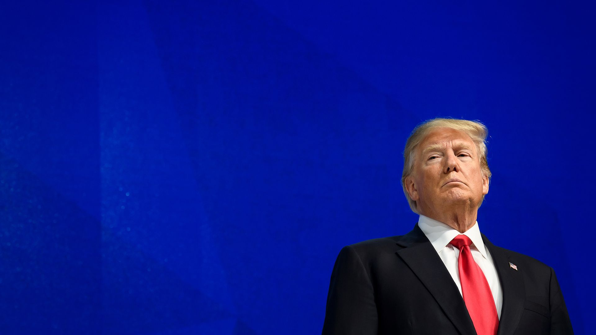 Trump at Davos against a blue background