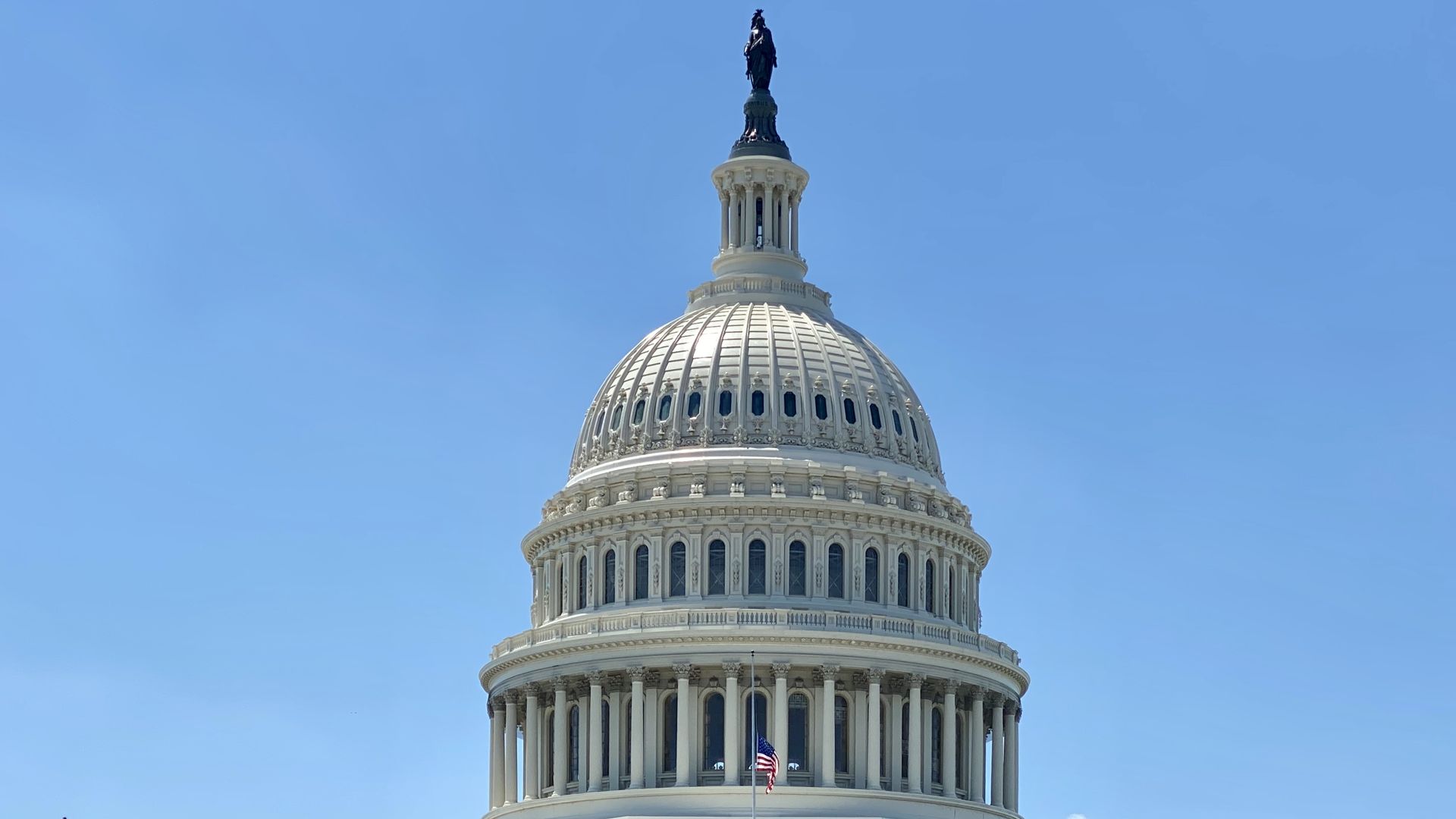A photo of the U.S. Capitol Dome in front of a clear sky.