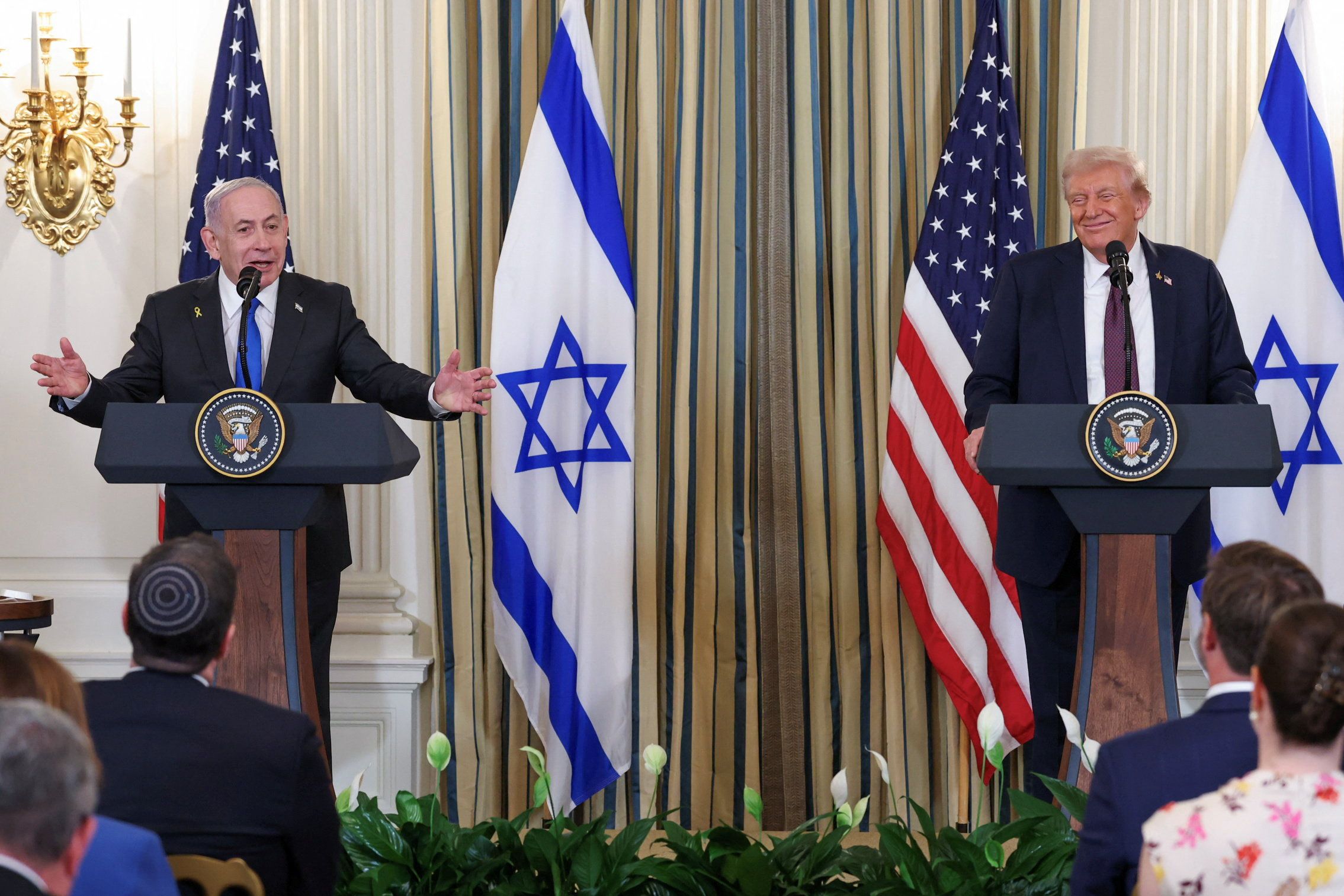 . President Donald Trump and Israeli Prime Minister Benjamin Netanyahu react during a joint press conference in the State Dining Room at the White House in Washington, D.C., U.S., September 29, 2025. REUTERS/Jonathan Ernst