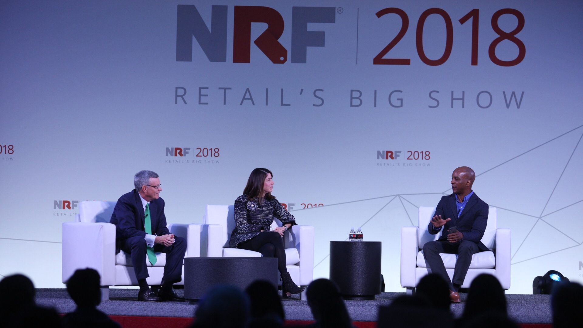 Visa CEO Al Kelly, Neiman Marcus CEO Karen Katz, and CNBC's Jon Fortt speak onstage at the National Retail Federation's Big Show Conference.