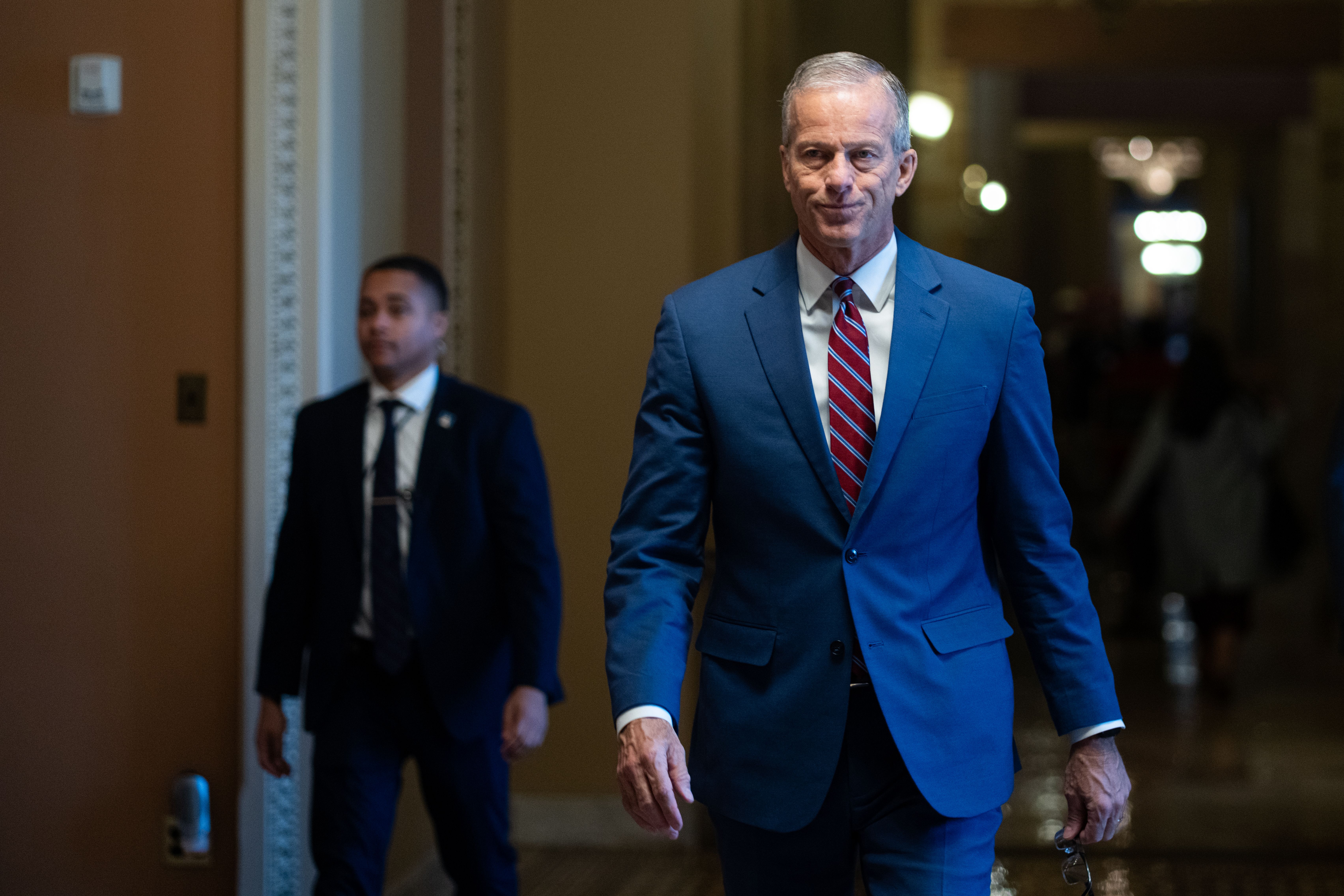 Senate Majority Leader John Thune walks through the U.S. Capitol toward the Senate floor.