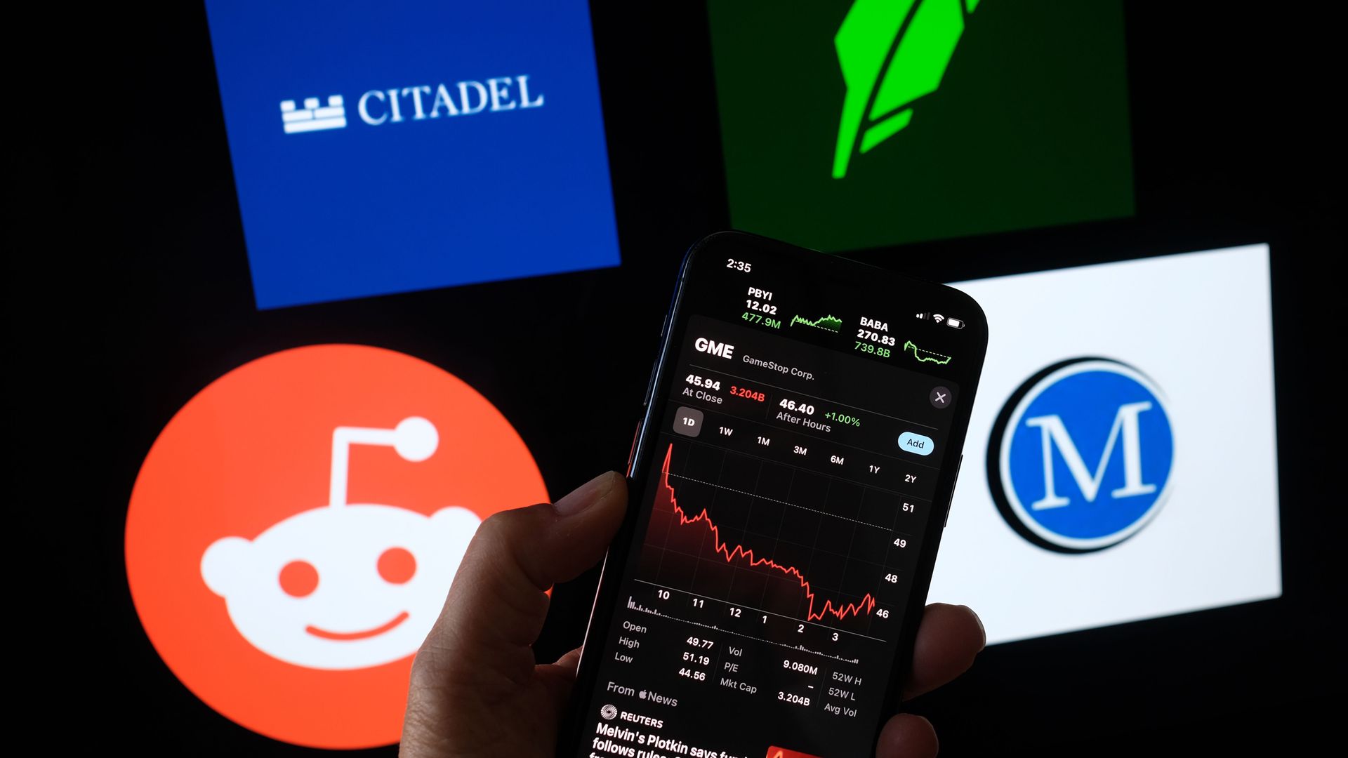 A phone in front of the logos of several companies