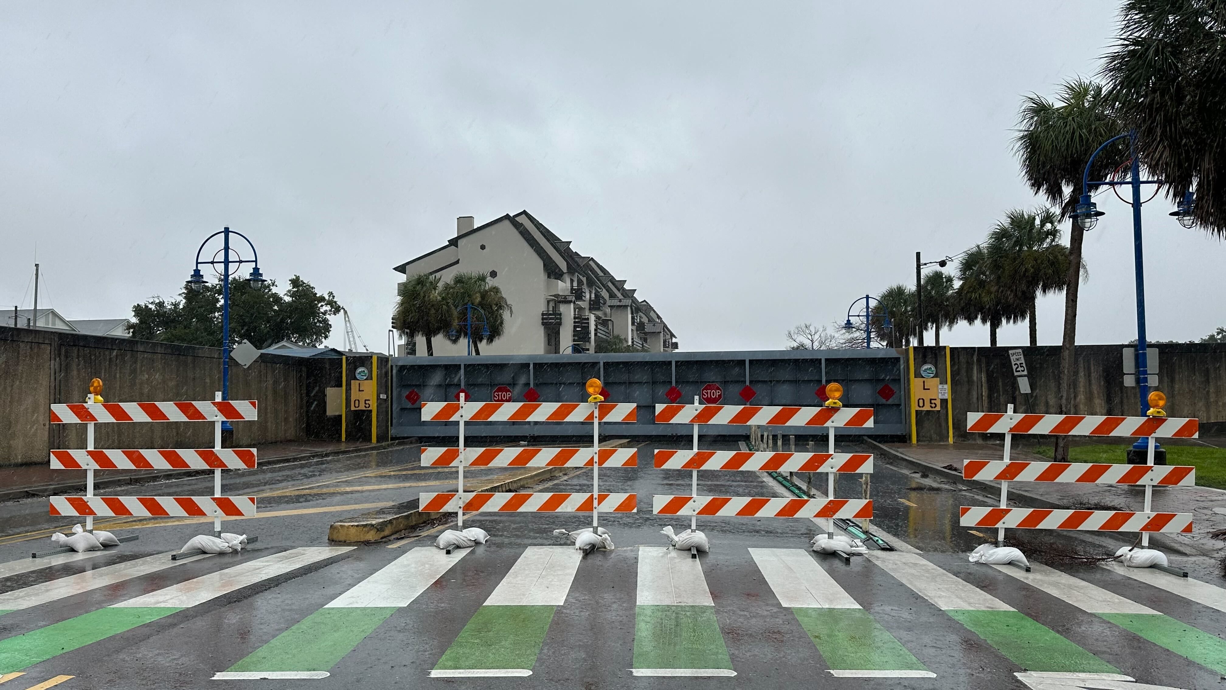 Emergency barricades block a closed floodgate.